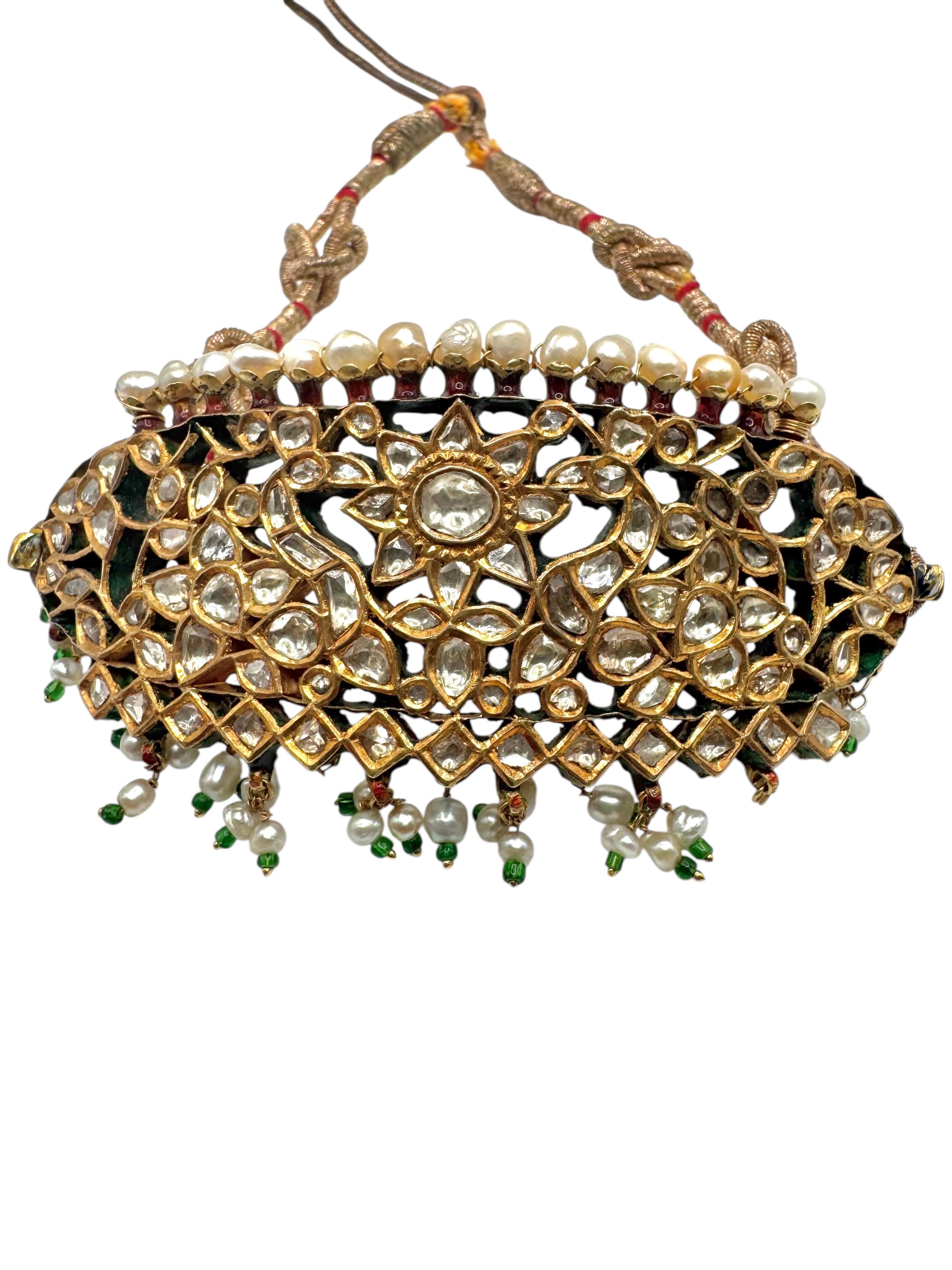 An exceptional and rare 18th-century Indian bazuband (armband) crafted circa 1775. This exquisite piece showcases the artistry of the period with a striking dual-sided design. One side features dazzling polki diamonds, meticulously set to create a