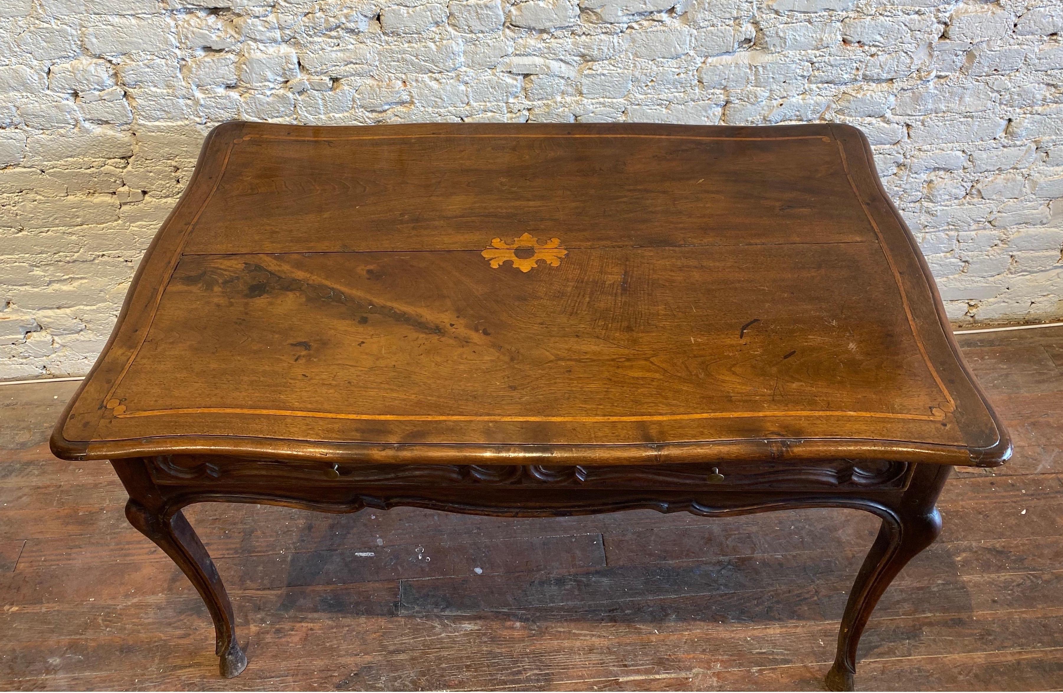 18th century inlaid French walnut hoof foot single drawer table or desk. Great color. Shaped molded top on slender legs with hoof feet.