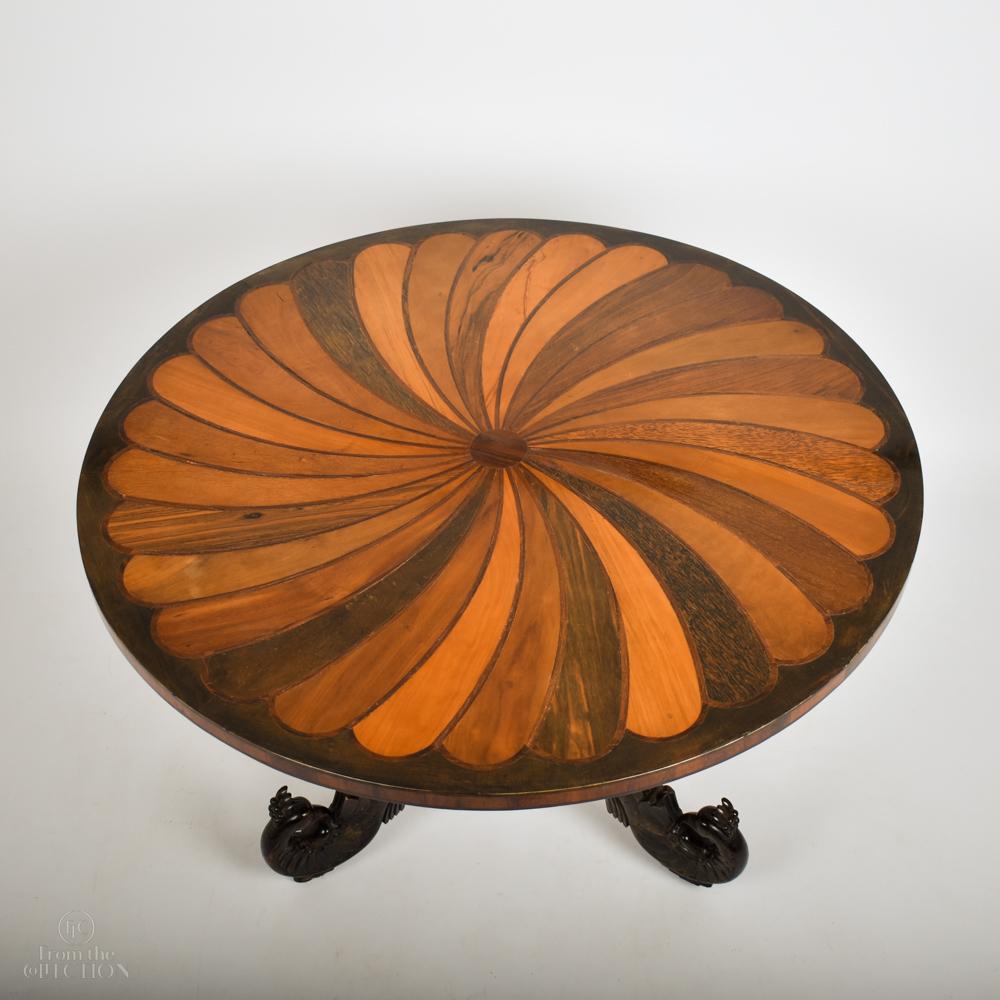 Inlaid tilt top circular pedestal table circa. 1780. With a variety of fruitwoods inlaid in a spiraling pattern to the top. An unusual design of exceptional colours and condition. The table top on a tilt mechanism on a carved pedestal column with