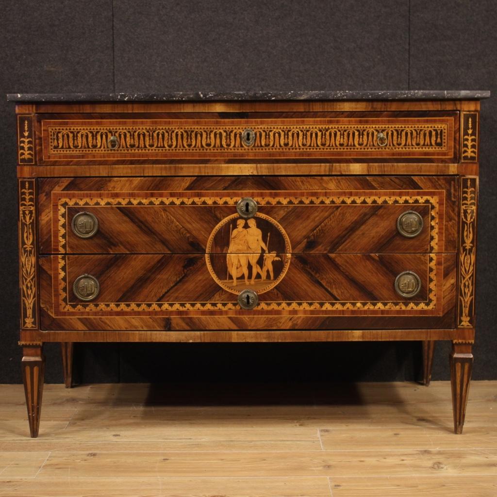 Antique Italian chest of drawers from the late 18th century. Furniture from the Louis XVI period richly inlaid in various precious woods including walnut, rosewood, maple, boxwood and fruitwood with neoclassical scenes placed on the sides and on the