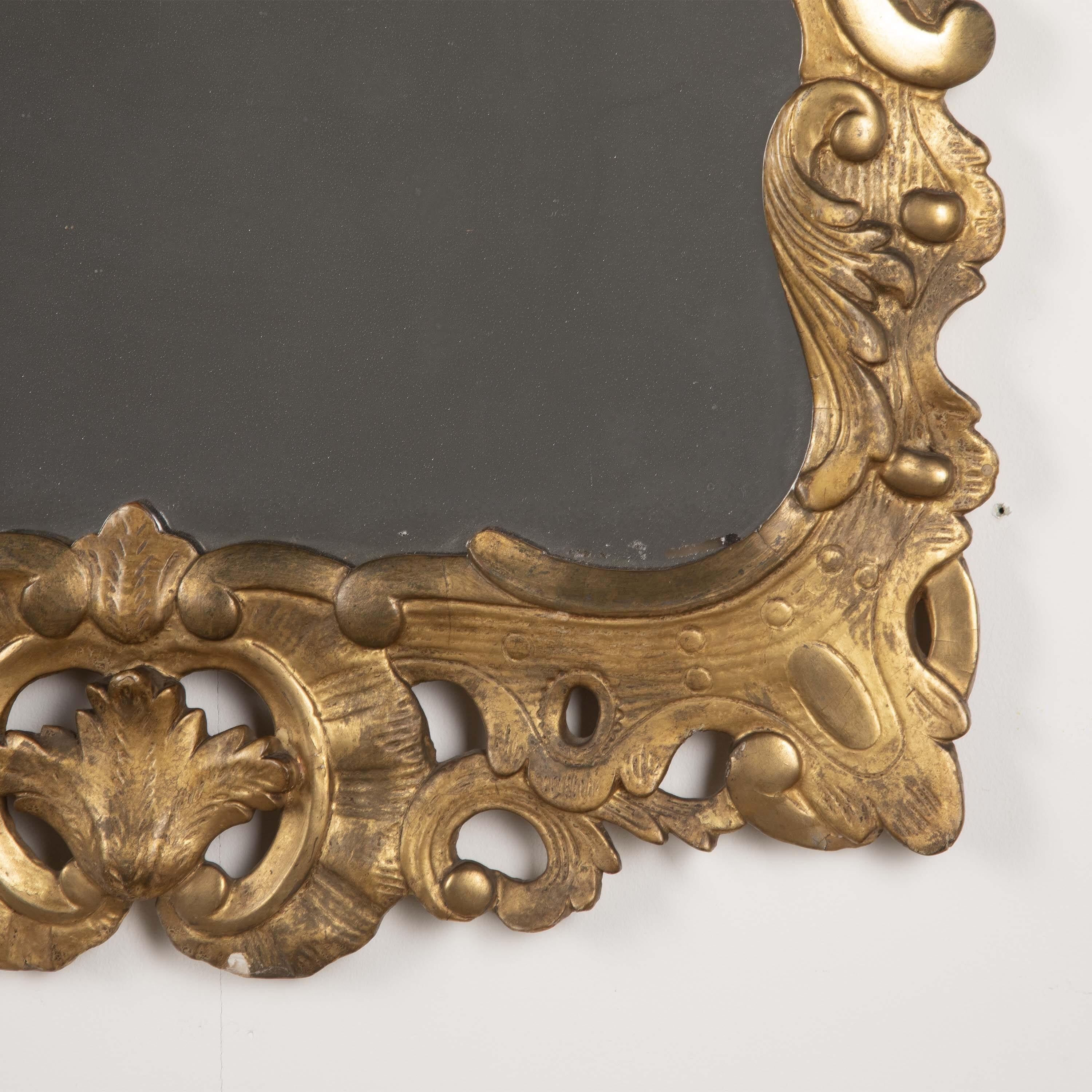 
Home / Stock / 18th Century Irish Carved Giltwood Mirror
PrevNext
A good quality George III carved giltwood Irish wall mirror, the scallop crest with foliate swags above a shaped frame and flanked by further trailing foliage, with scrolls and