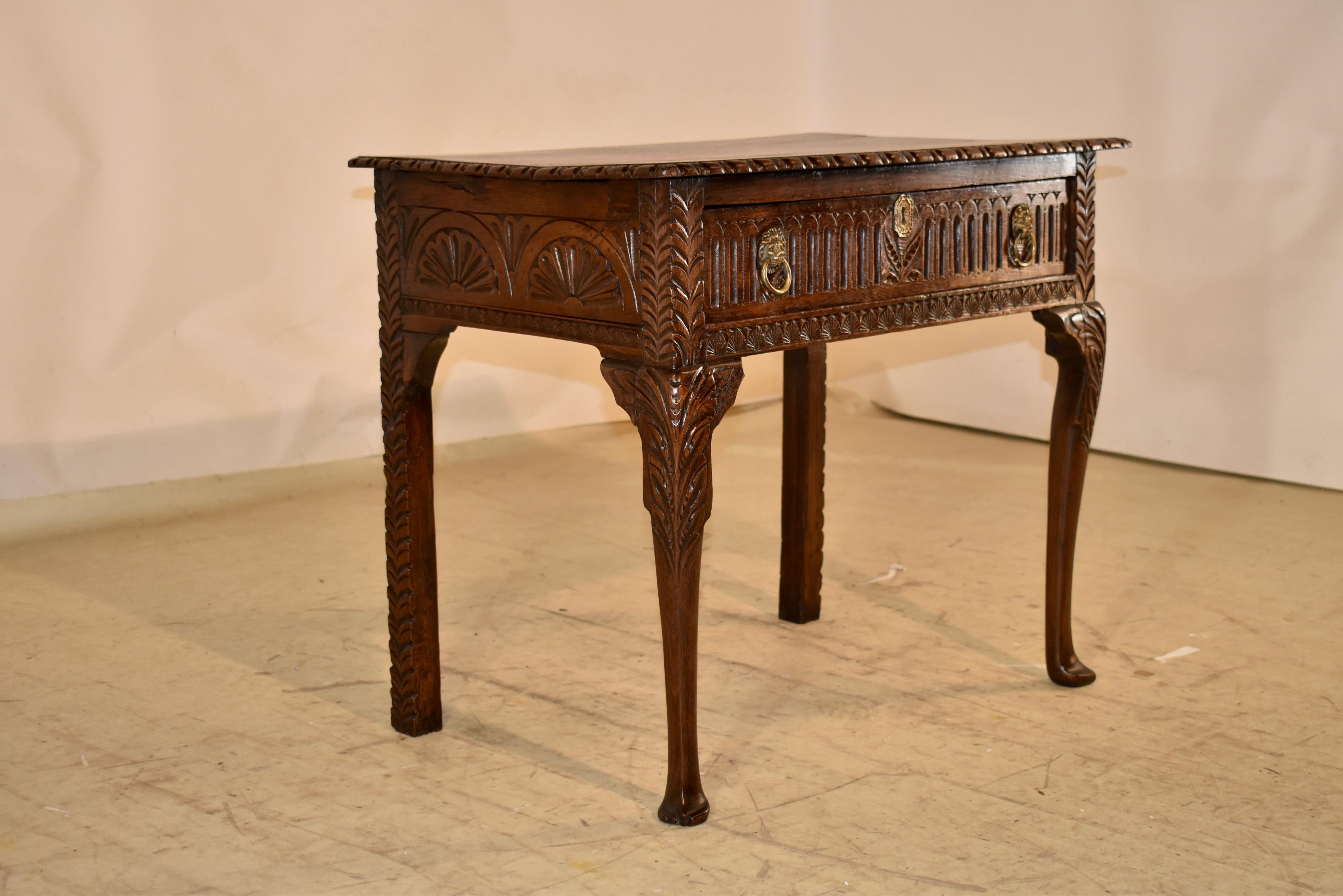 18th century oak lowboy from Ireland.  The top has lovely graining and color, and has a hand carved decorated edge, following down to hand carved decorated sides and a single drawer in the front, which has reeded carved decoration.  The drawer is
