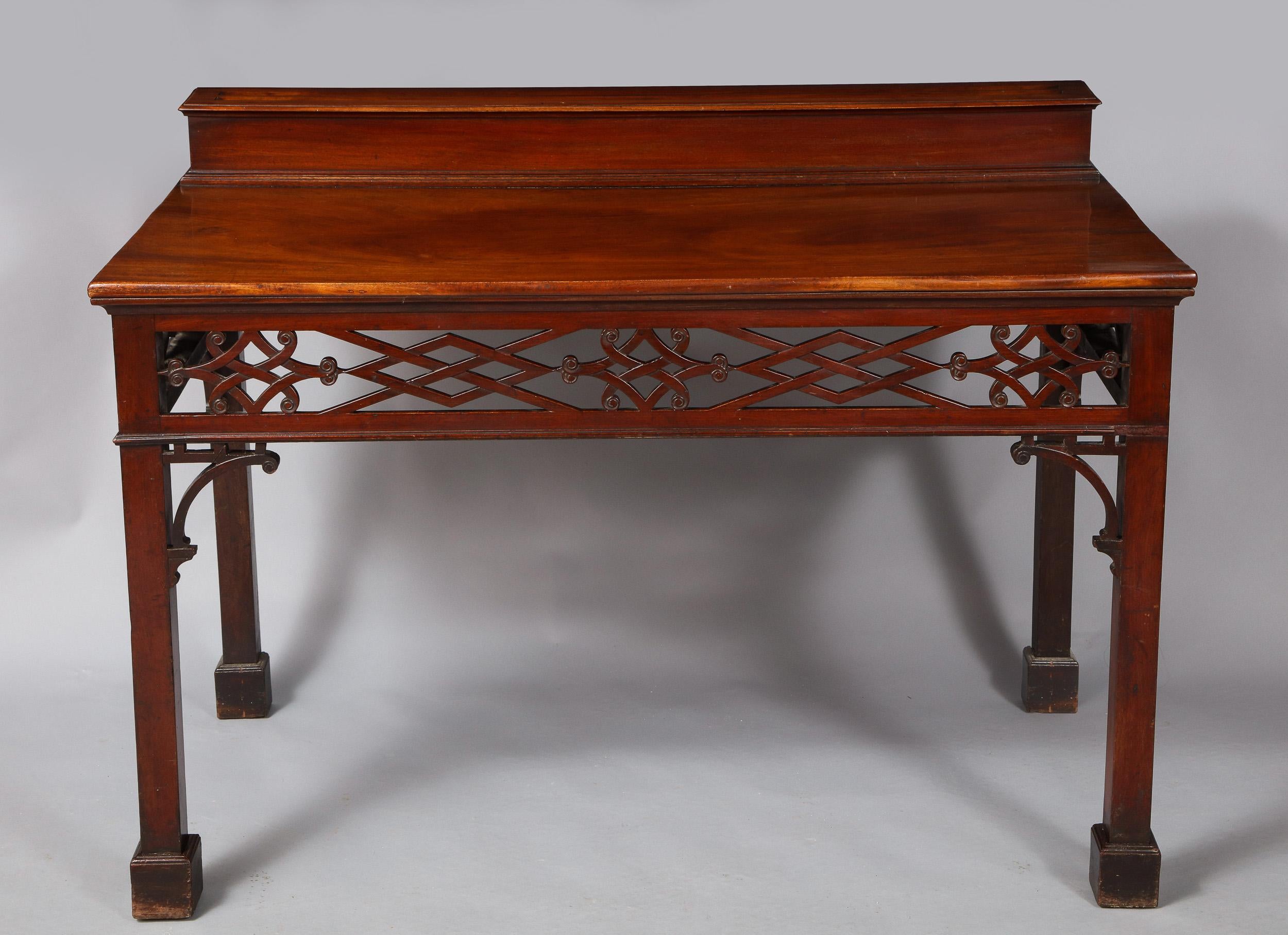 Very fine 18th century Irish serving table with unusual superstructure for displaying plate, having two notched grooves over plinth base, the well figured single plank top over trellis pierce carved apron, the square legs with flying open brackets