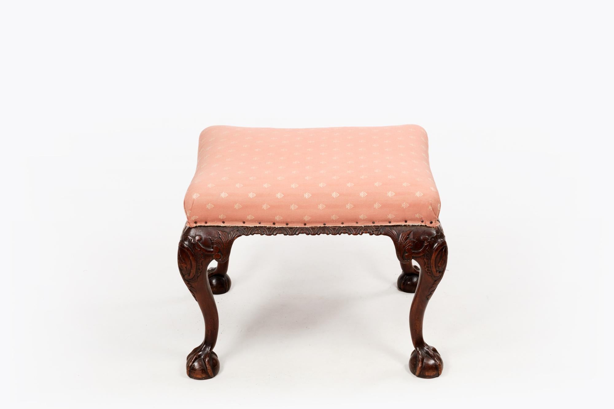 Late 18th century Irish mahogany stool with beautifully carved ribbed sides, upholstered top and raised on acanthus carved cabriole legs with ball & claw feet.