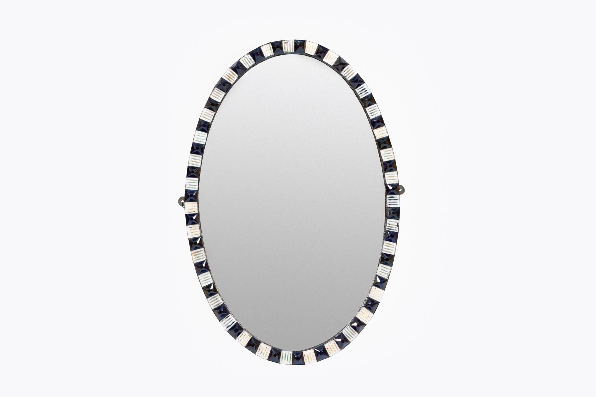 18th century Irish Waterford mirror, the period plate of oval form set within frame of alternating faceted blue and clear glass studs.