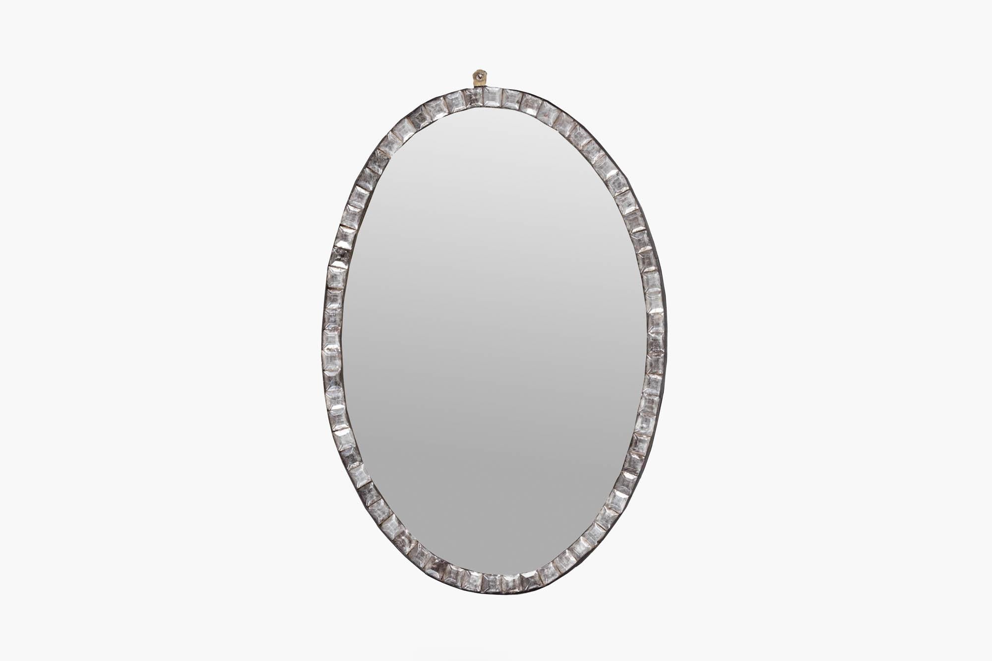 Early Irish Waterford oval mirror with beveled glass and clear glass studs. This beautifully emulates the Waterford style & features the original glass plate. Circa 1760.