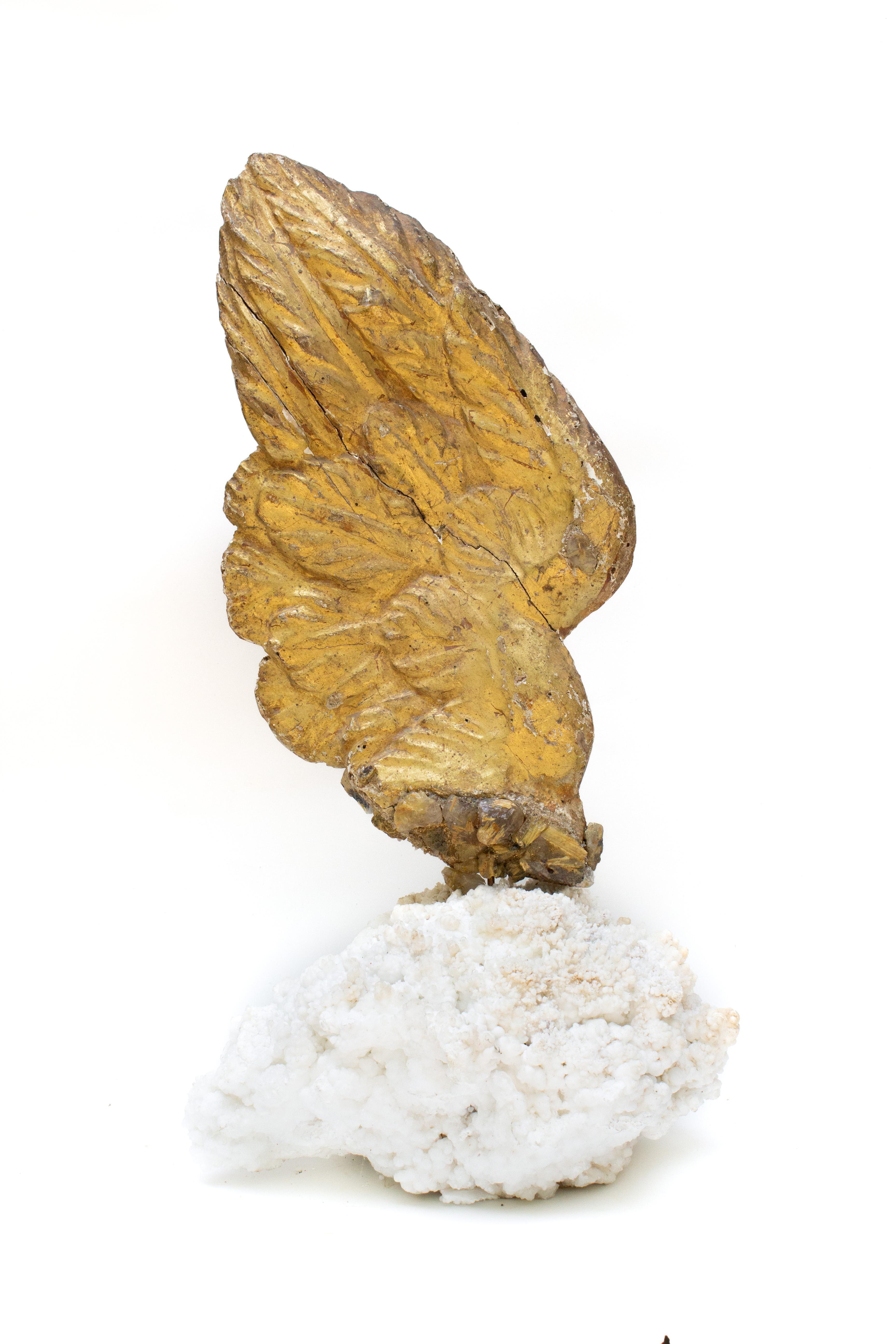 18th century Italian gold leaf angel wing with rutilated quartz crystals on natural-forming aragonite crystal cluster. The hand-carved angel wing was once part of a heavenly, angelic depiction in a historic church in Italy. 

The aragonite is from