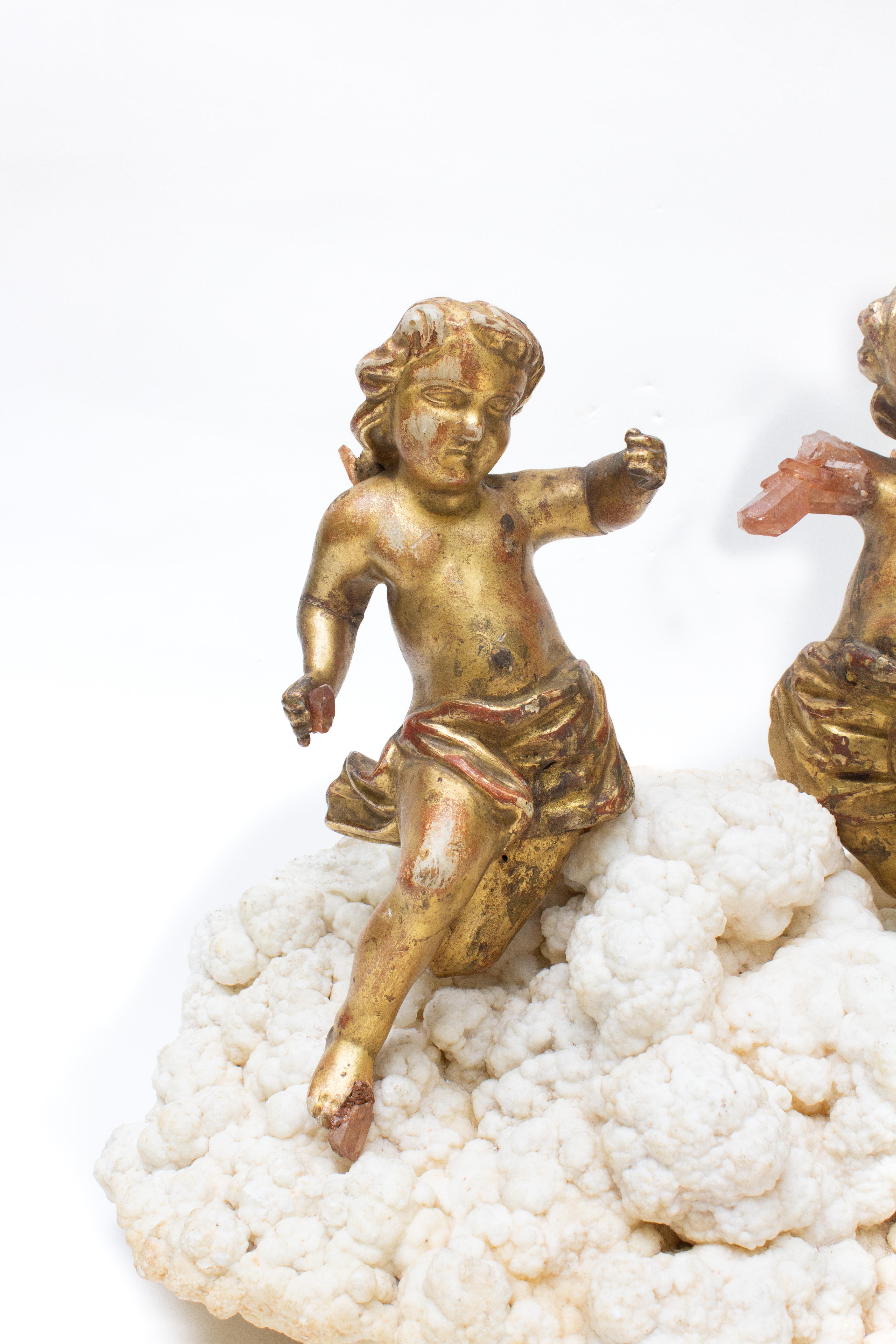 Paire d'anges italiens du XVIIIe siècle sculptés à la main à la feuille d'or avec des cristaux de quartz tangerine et montés sur de l'aragonite. Les anges sculptés à la main faisaient autrefois partie d'une représentation céleste et angélique dans