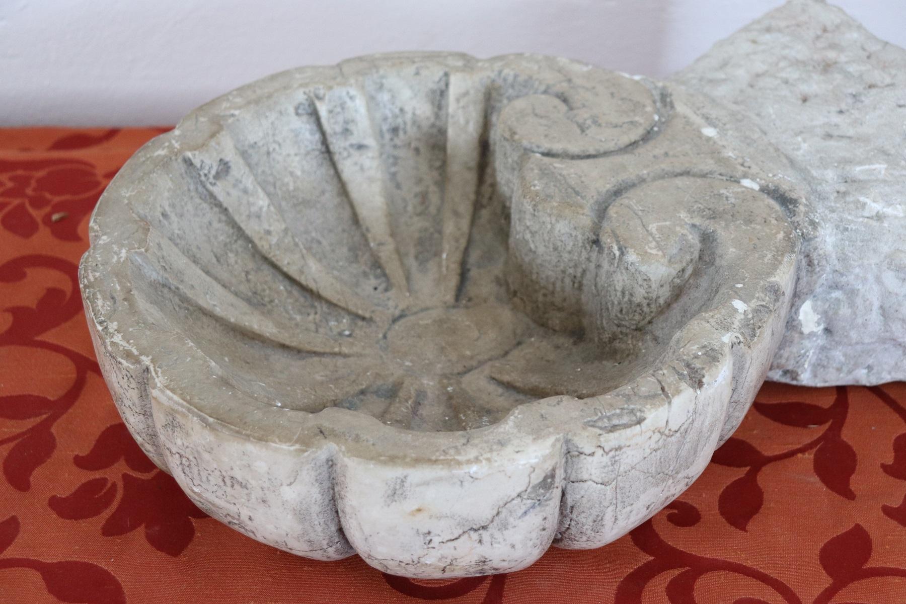 Beautiful rare Italian carved Carrara white marble font. Authentic Baroque era. The holy water font has a typical shell shape. Marble has the patina and the fascinating signs of wear due to all these past centuries. It comes from an Italian private
