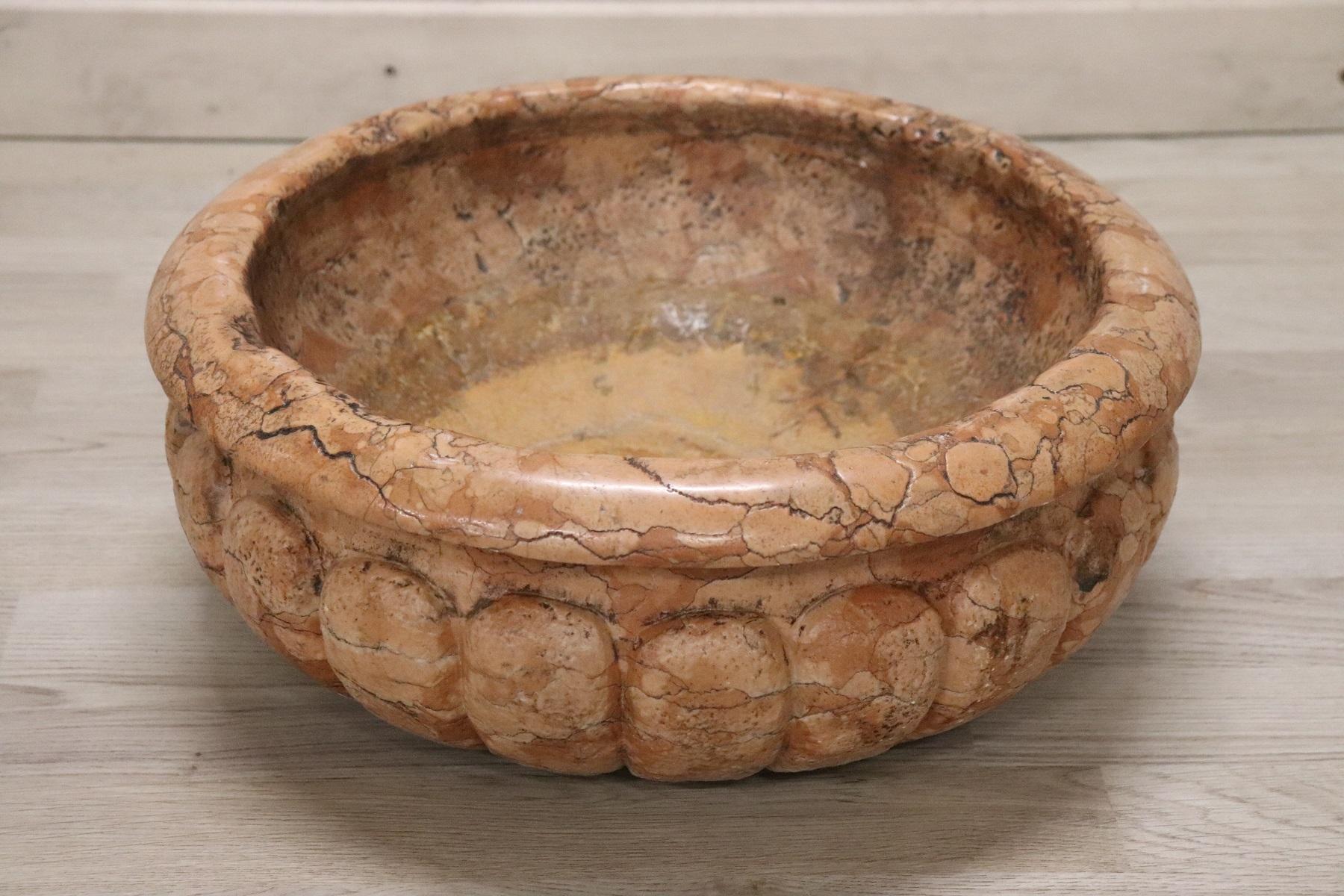 Beautiful rare Italian carved marble of Siena red earth color font. Authentic Baroque era. The holy water font has a typical round shape. Marble has the patina and the fascinating signs of wear due to all these past centuries. It comes from an