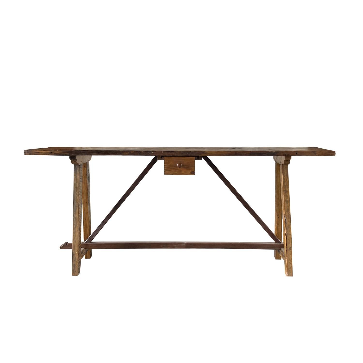 A late 18th Century Italian rustic primitive console table with cross-stretchers and a single drawer, in good condition. This nicely constructed freestanding side, end table is hand made in warm and luminous Walnut wood with original patina. Wear
