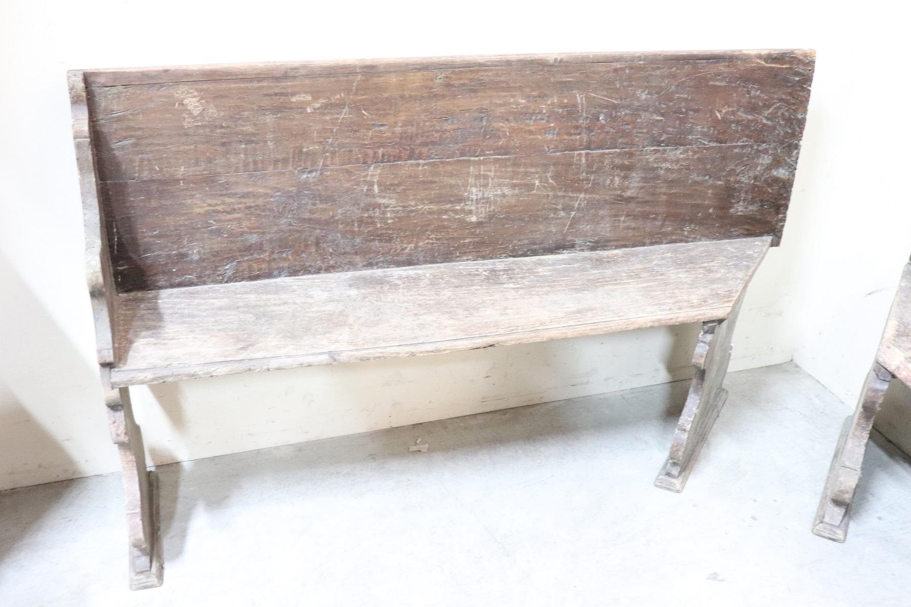 Rare Italian corner bench 1750s. Made of solid walnut wood. The bench is made up of two pieces. The length of the two pieces is 170 cm on one side and 117 cm on the other side. The bench shows signs related to the wear and tear of all the past
