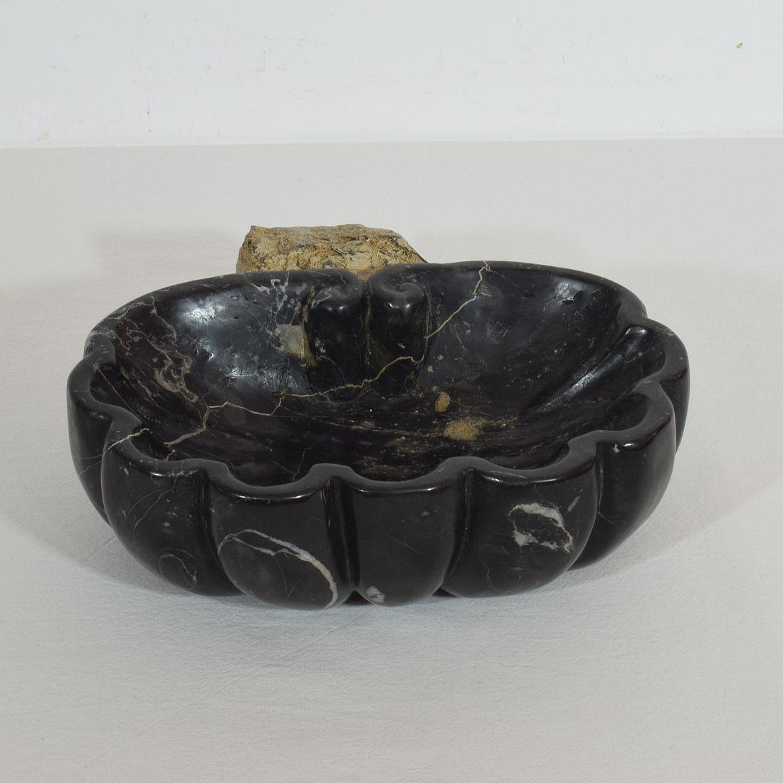 Unique Baroque black marble holy water font or stoup with great patina, Italy, circa 1750.
Weathered, old repair.