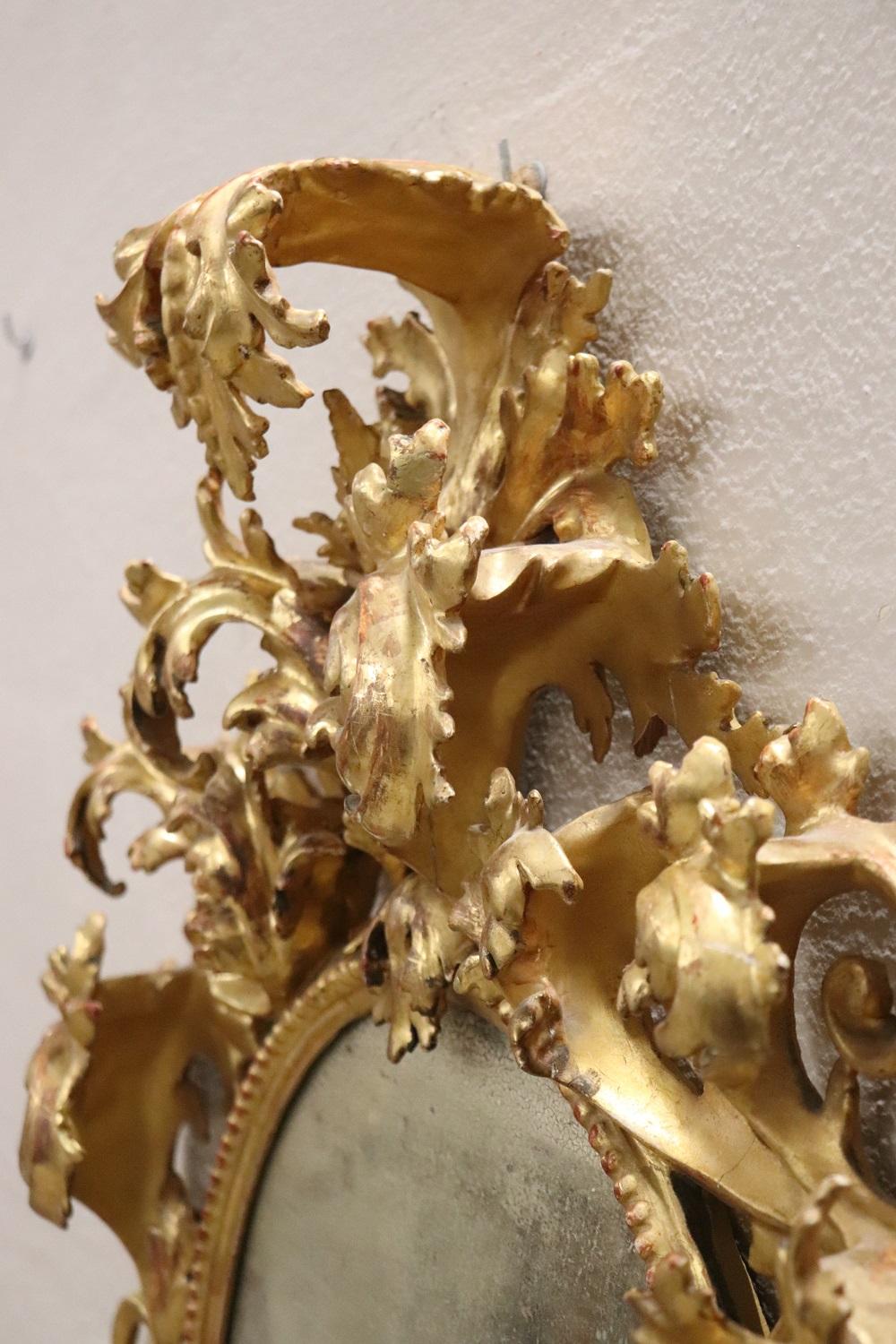 Hand-Carved 18th Century Italian Baroque Carved Gilded Wood Oval Wall Mirror For Sale