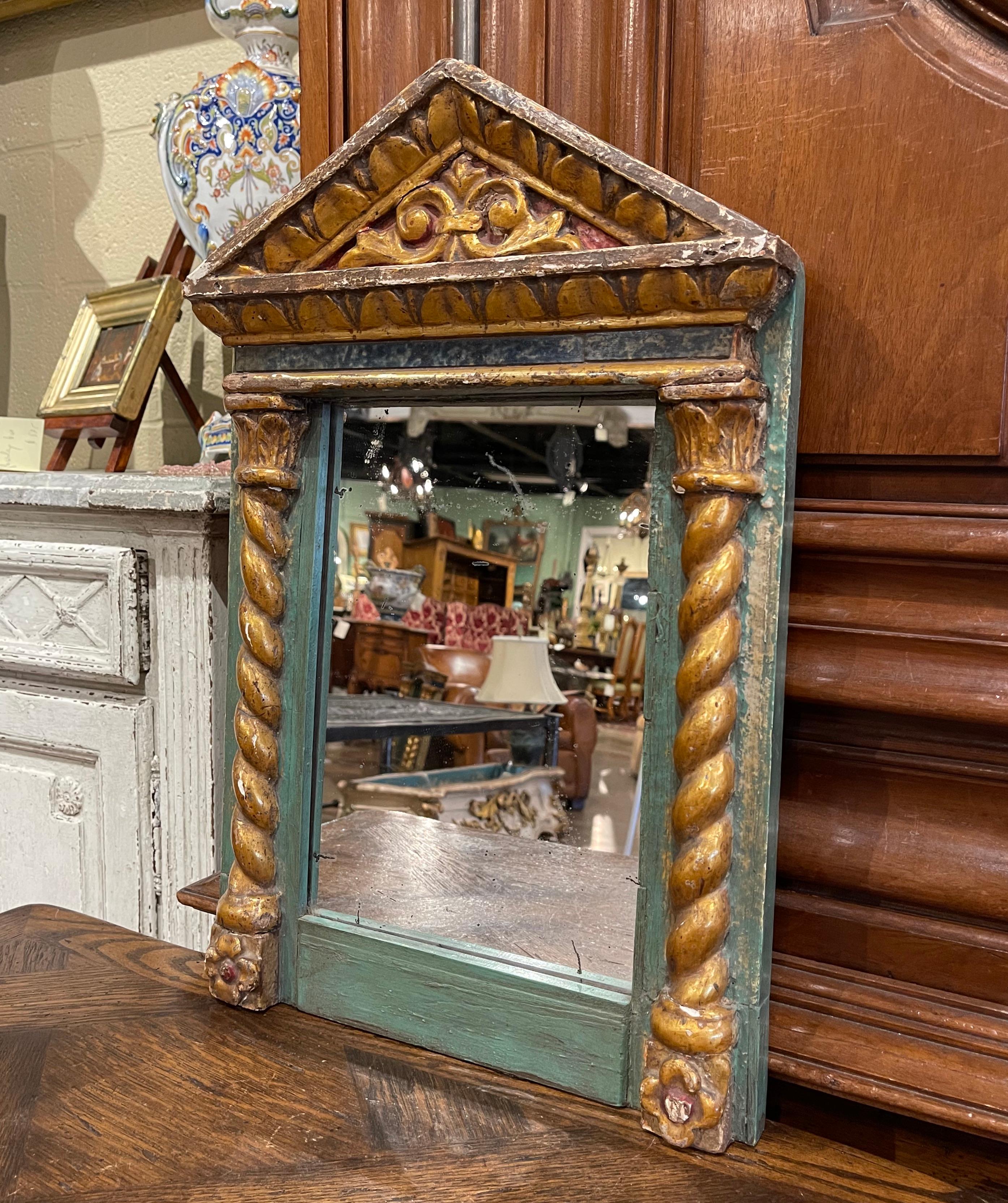 Add a dose of Baroque drama to your home with this elegant antique gilt and painted mirror. Crafted in Italy, circa 1780, the small wall hanging mirror features a cathedral shape top embellished with scrolled and geometric motifs and the frame is