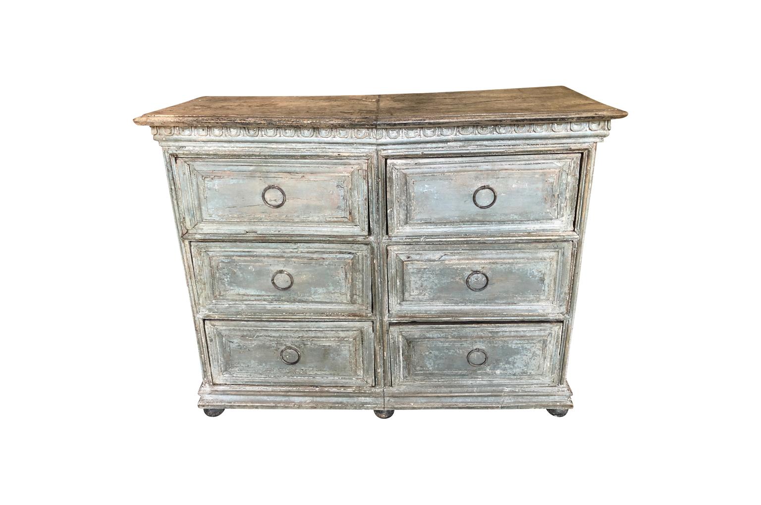 A very handsome 18th century Baroque commode from the Lombardi region of Italy. Wonderfully construction from painted wood with 6 drawers, dentilated detail raised on ball feet. Terrific finish and patina.
