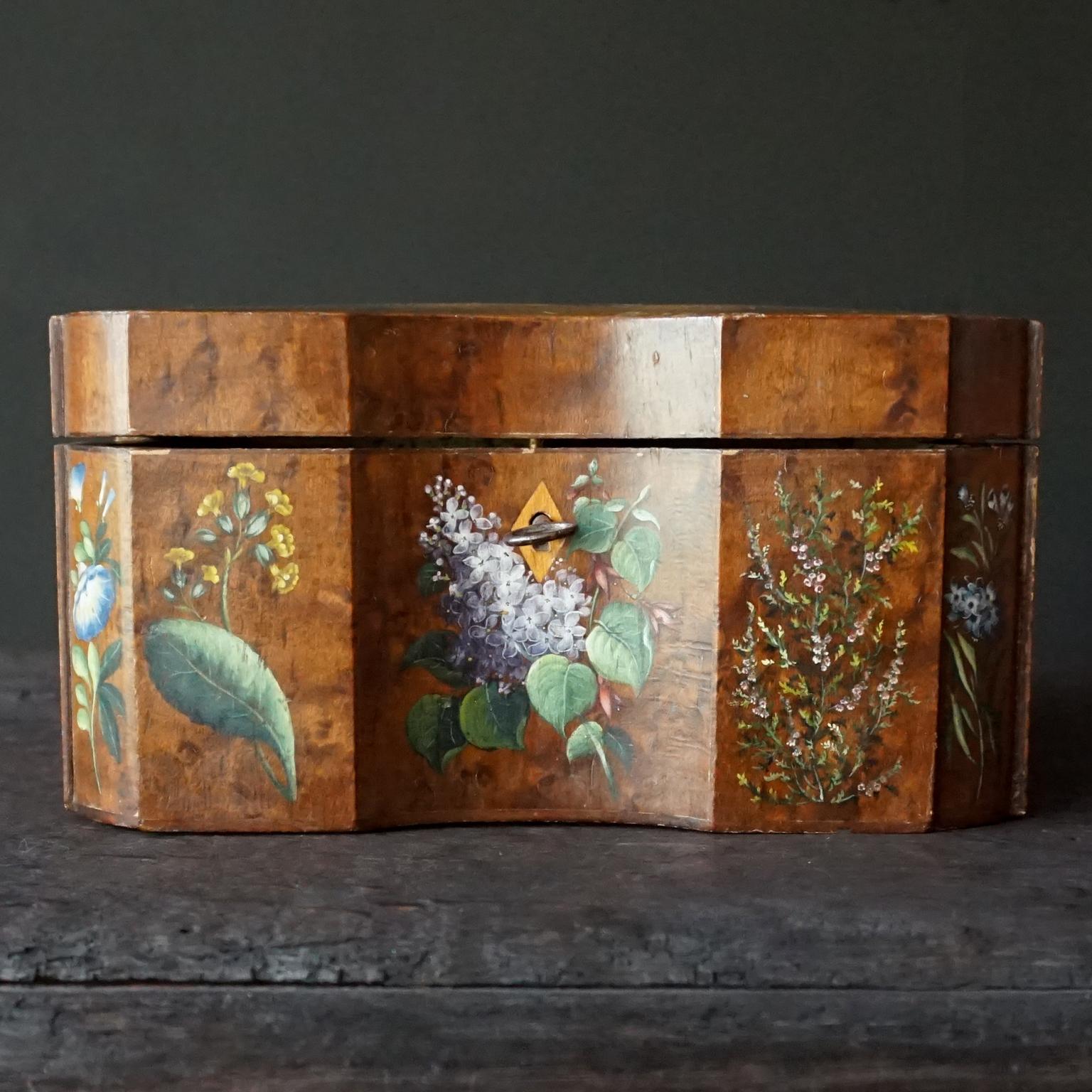 Very pretty 18th Century decorative shaped box, it used to be a tea caddy and is made in wood with burl wood veneer and hand painted decoration.
Back from the days when tea was worth its weight in gold and it needed to be kept in pretty boxes.
On
