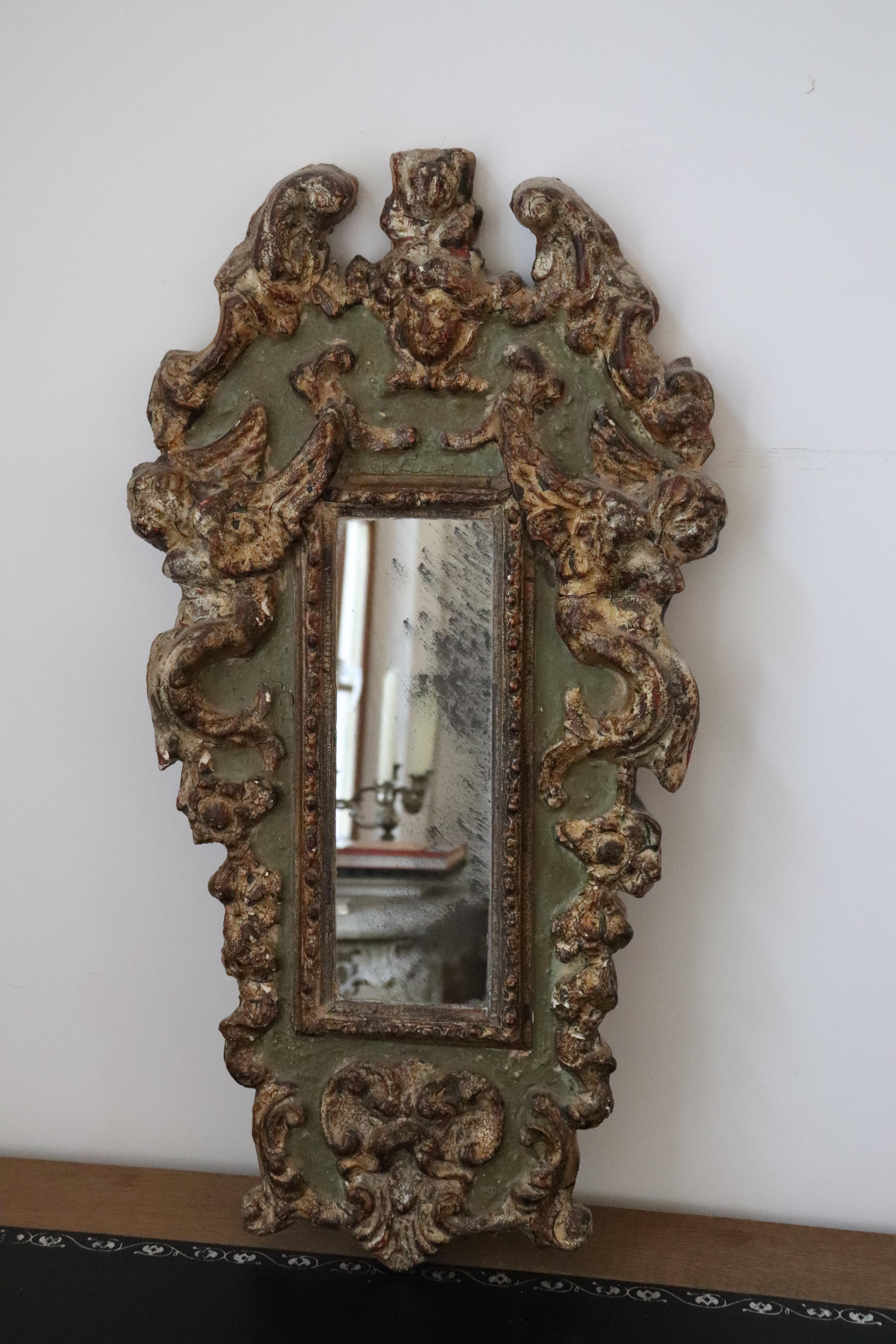 An early Italian 18th century polychromed and part gilt mirror frame.
Carved with Cherubs and florals, and set with a rectangular mirror.
Beautiful weathering in the mirror glass.
A real representative piece of Italian gilt wood art.
Top