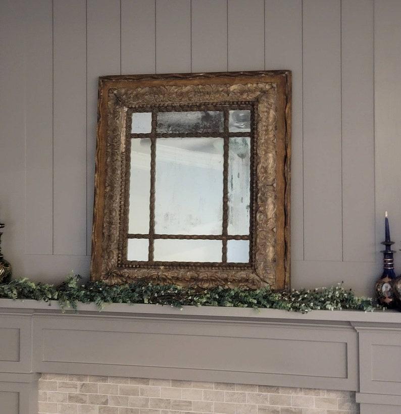 This exceptionally carved Baroque period Italian mirrored mercury glass giltwood wall hanging / mantel mirror captures the reason why we love European antiques so much. Nothing adds character to a piece like the time-worn, natural patina that only