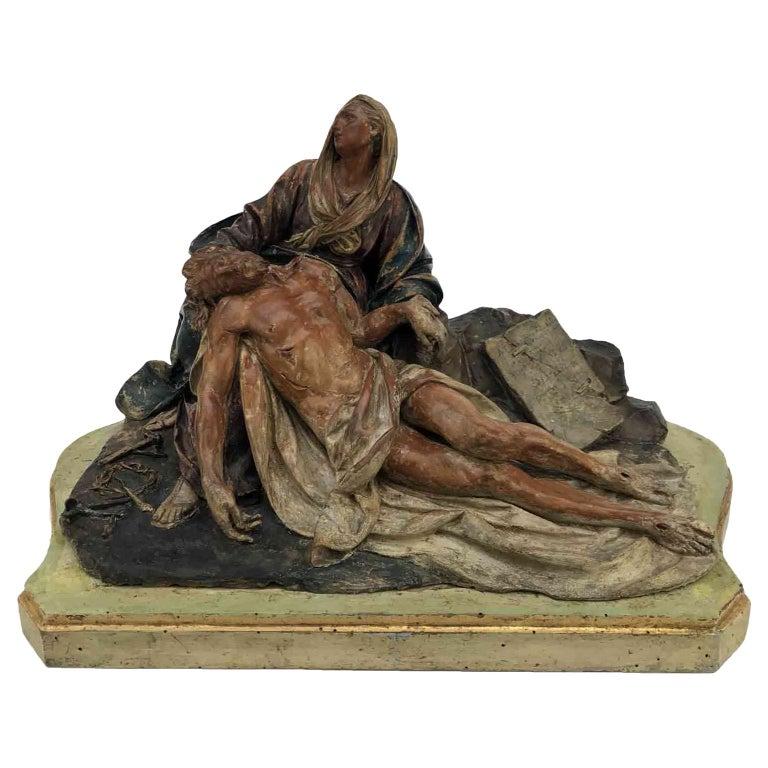 A stunning Italian Polychrome Earthenware Pietà Pity dating back to 18th century of Bolognese circle of the master Angelo Gabriello Piò, Bologna 1690-1770, dating back to the first quarter of 18th century, in good age related condition, with minor