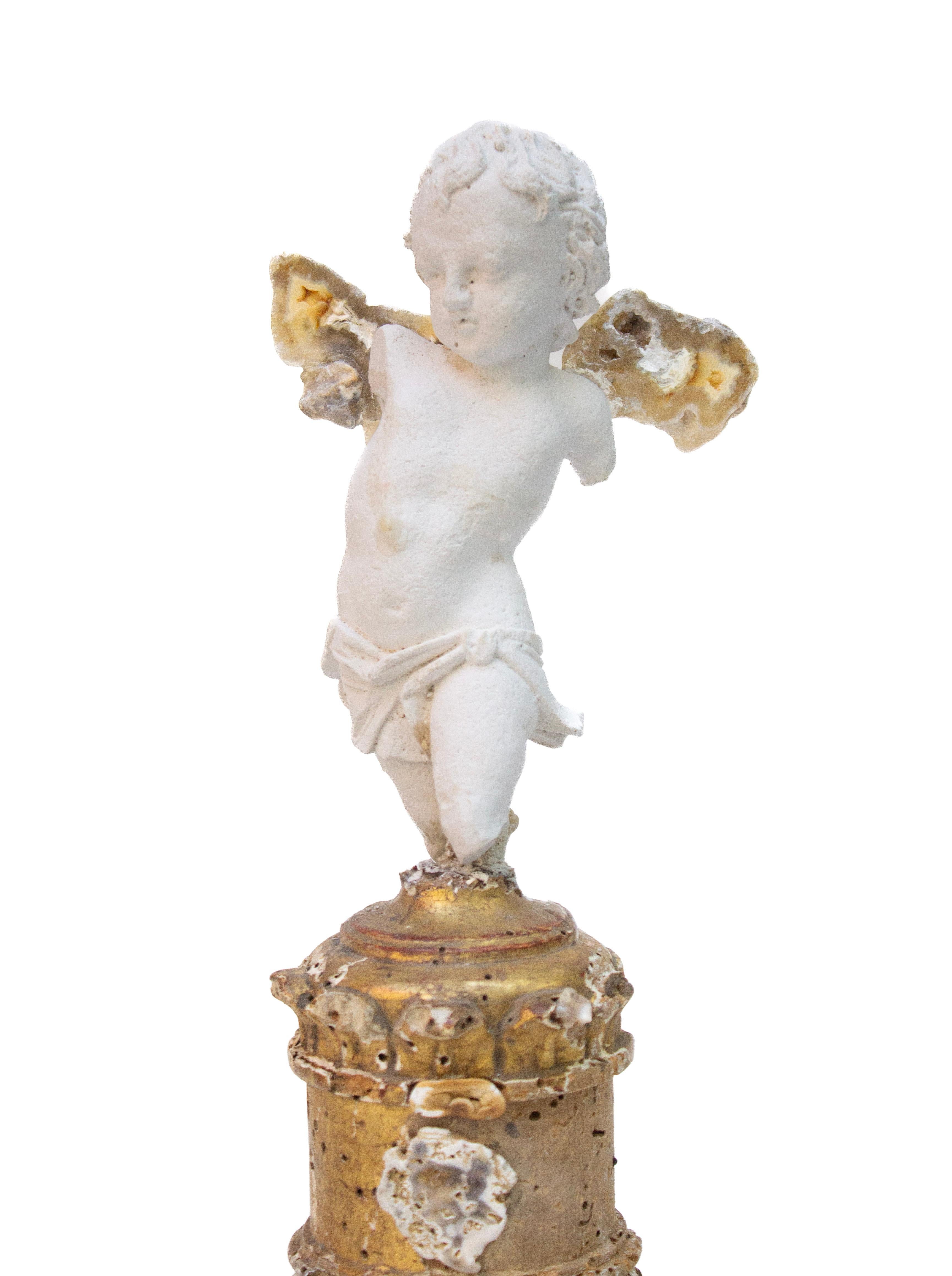 Italian plaster cherub with polished agate coral wings on an 18th century Italian gilded candlestick base with polished agate slices.

The Italian 18th century gilded base is originally from an altar candlestick from a historical Italian church. The