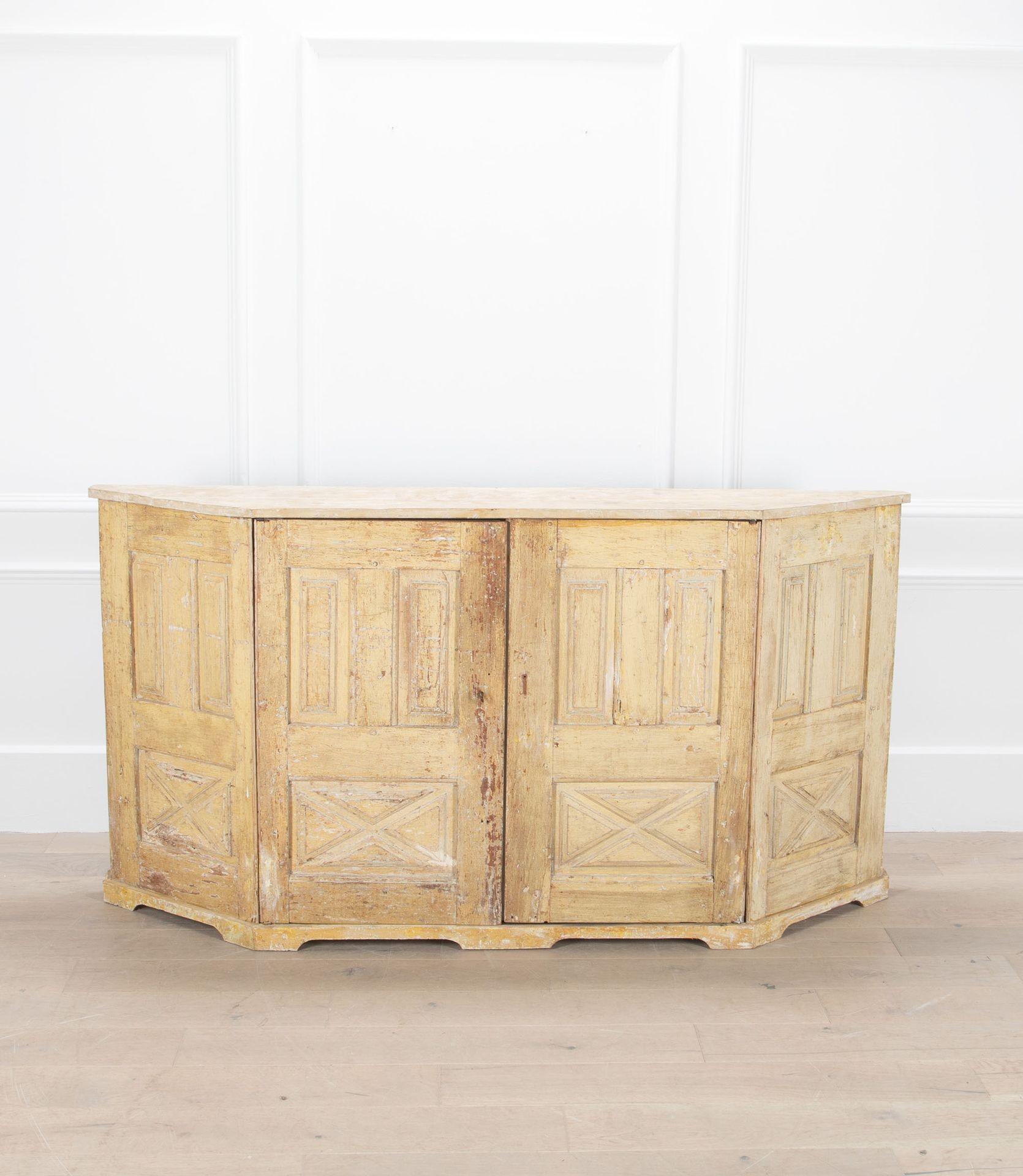 A superb 18th Century Italian buffet or sideboard in very original condition.

Made in pine with remains of old pale yellow paint - panelled front with canted ends.

Narrow in depth so it would be perfect in a hall or anywhere space is limited. An