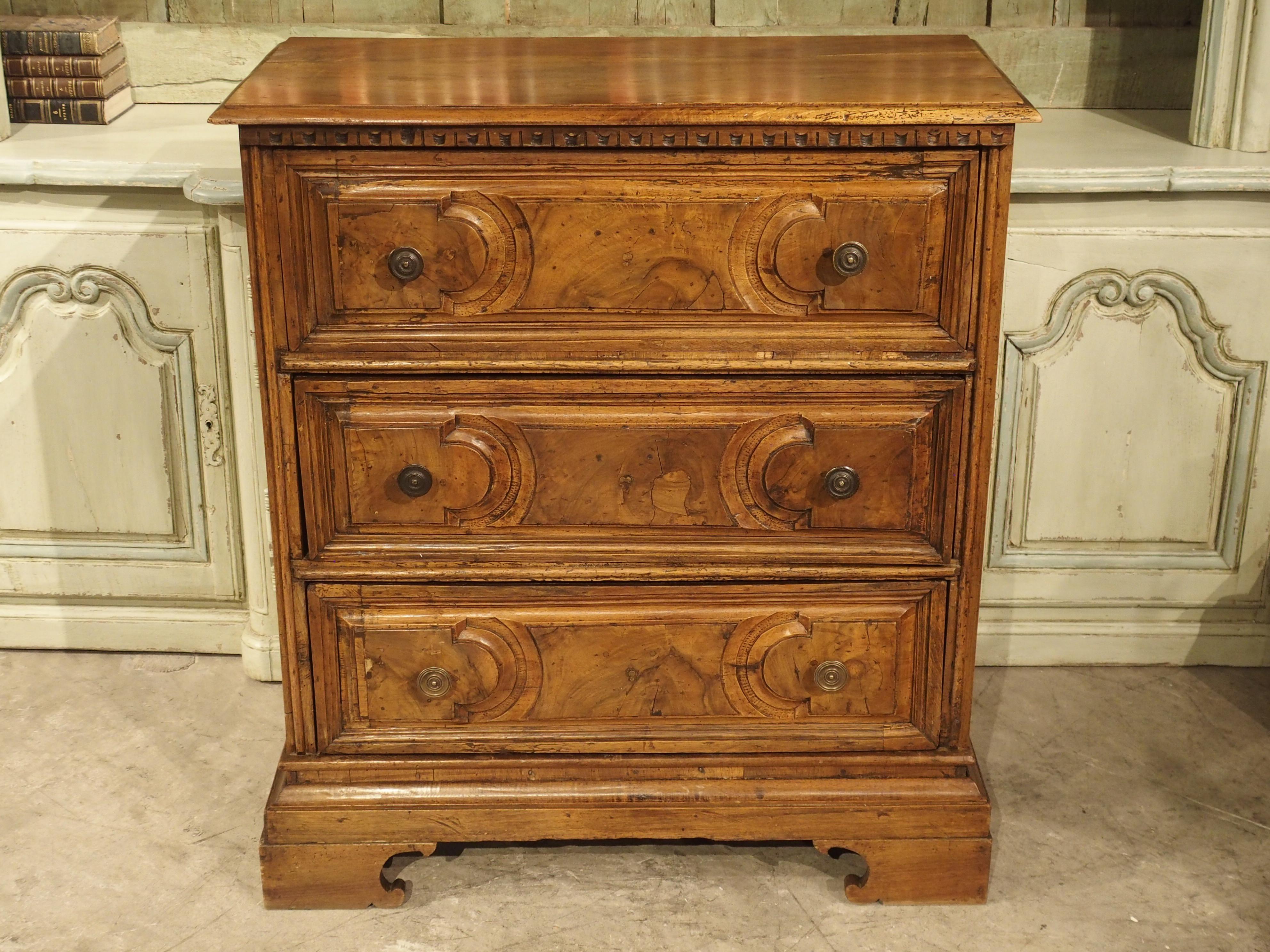 Hand carved during the 1700’s, this Italian chest of drawers features burl veneer and bronze pulls. A burl occurs when wood grain grows in a misshapen manner, as the result of stress to the tree. Burled wood is highly valued because it yields deeply