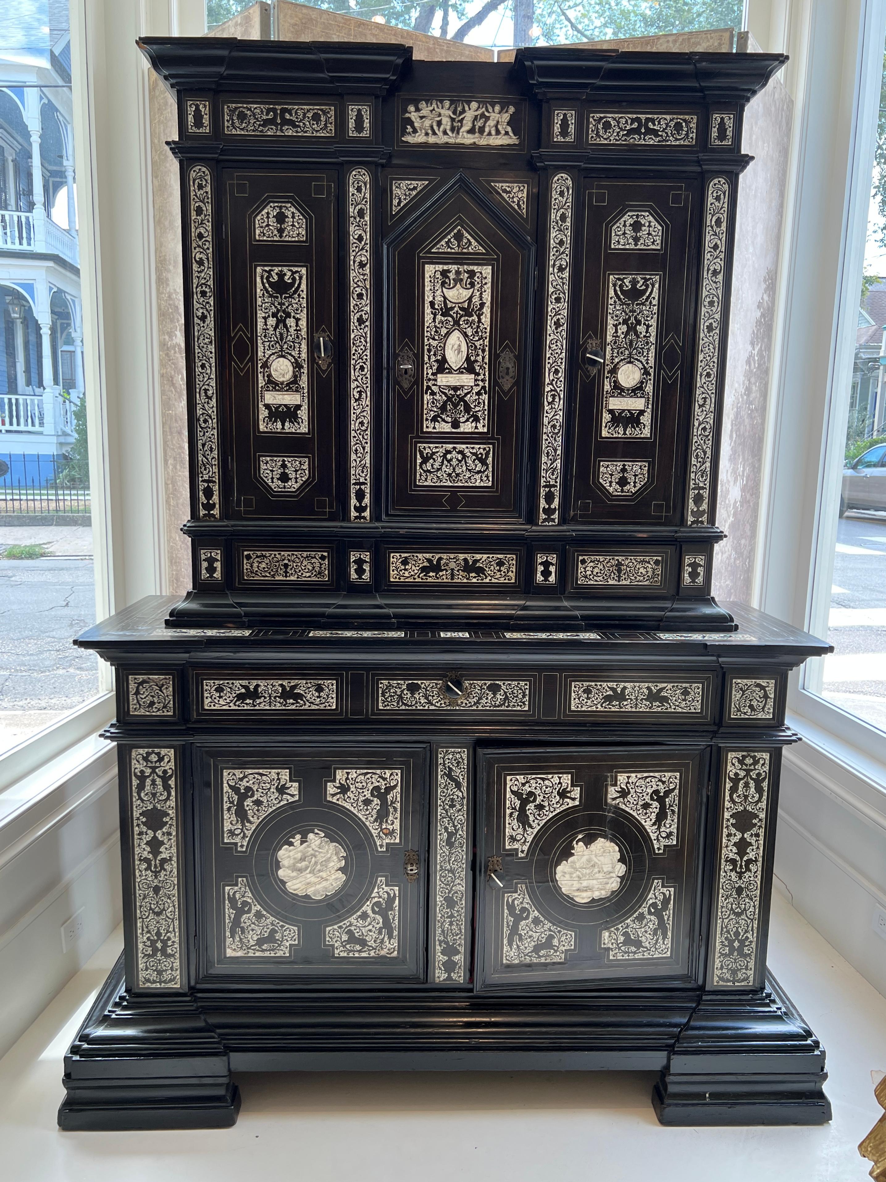 Behold this extraordinary cabinet by Fernando Pogliani from Milan that is a layered fantasia of ebony and bone. The front is intricately worked inlay depicting everything from angels and horses to peacocks and griffons. This is truly a wholly unique