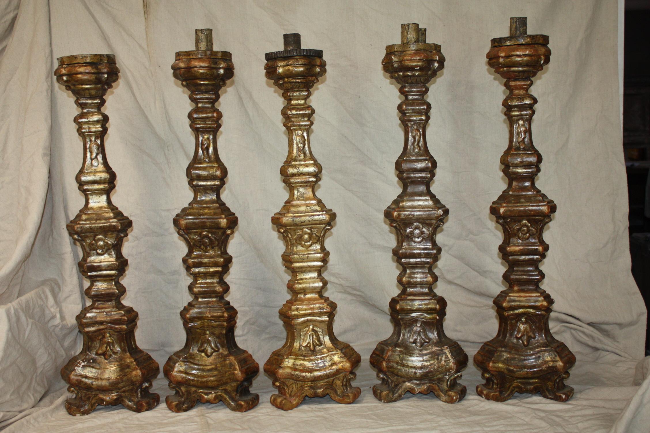 I bought a set of 5 18th century Italian candle sticks. They match in shape but have slight variations in the tone of the gilding. They are similarly carved on all three sides but have a definitive front that is gilded. The price is for an