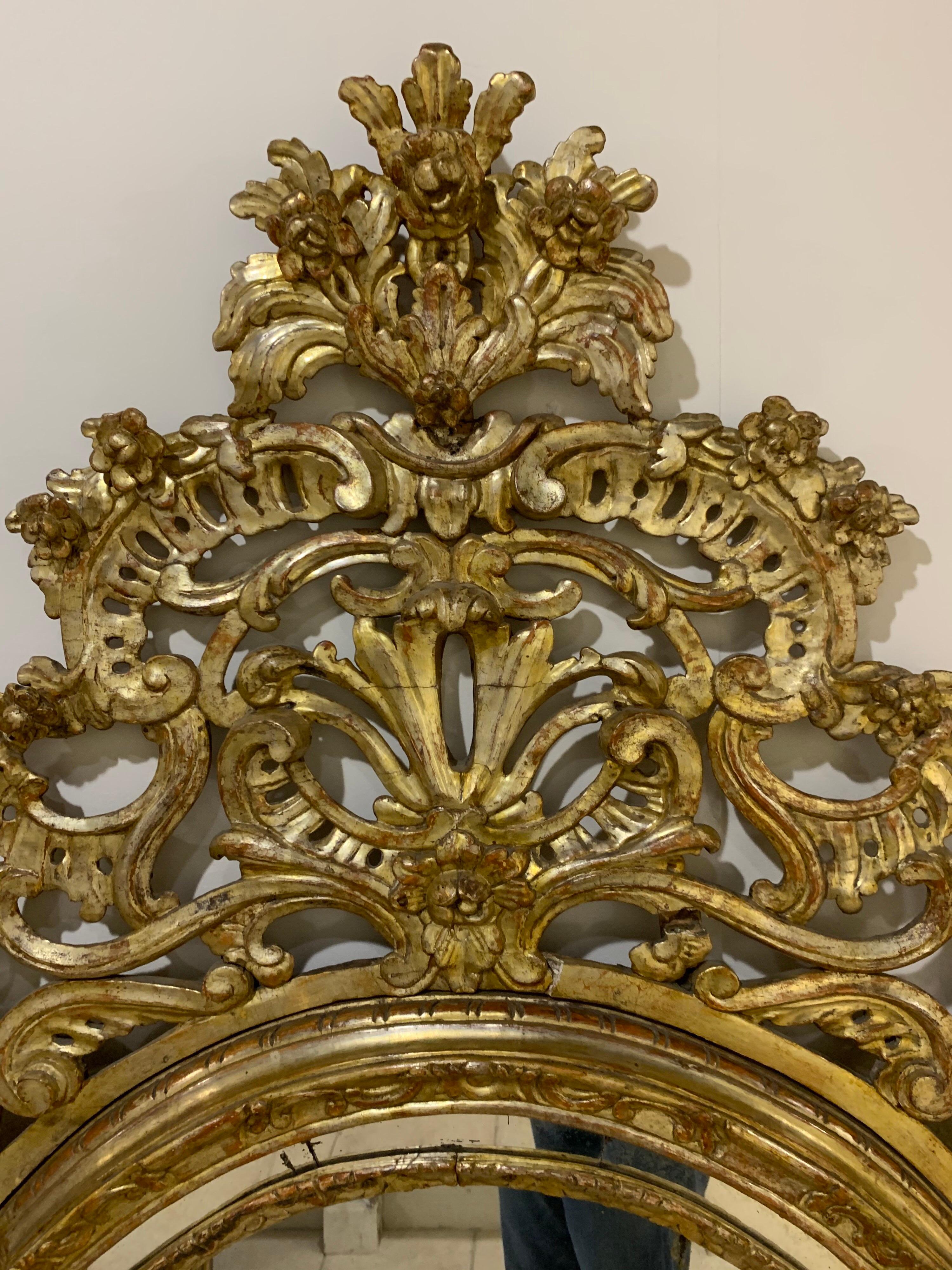 Elaborate 18th century carved and giltwood mirror. Exceptional carving and beautiful gilt on this piece. A true piece of art. Gorgeous!