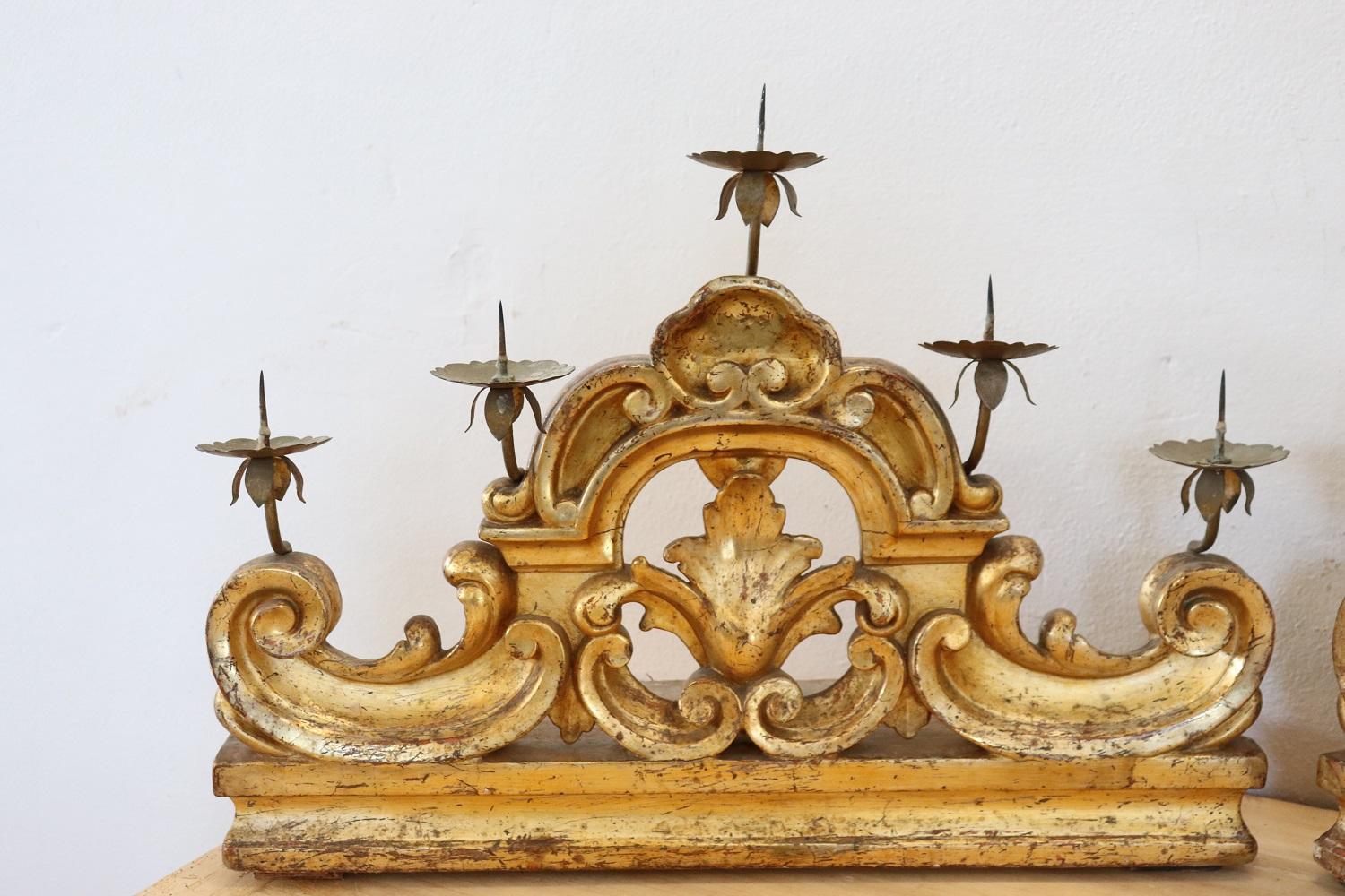 Rare large pair of antique table candelabrum in carved and giled wood with five arms for five candles. Great artistic quality of the 18th century, carved wood with rich decoration of curls and scrolls. There are some signs of wear in the gilding and