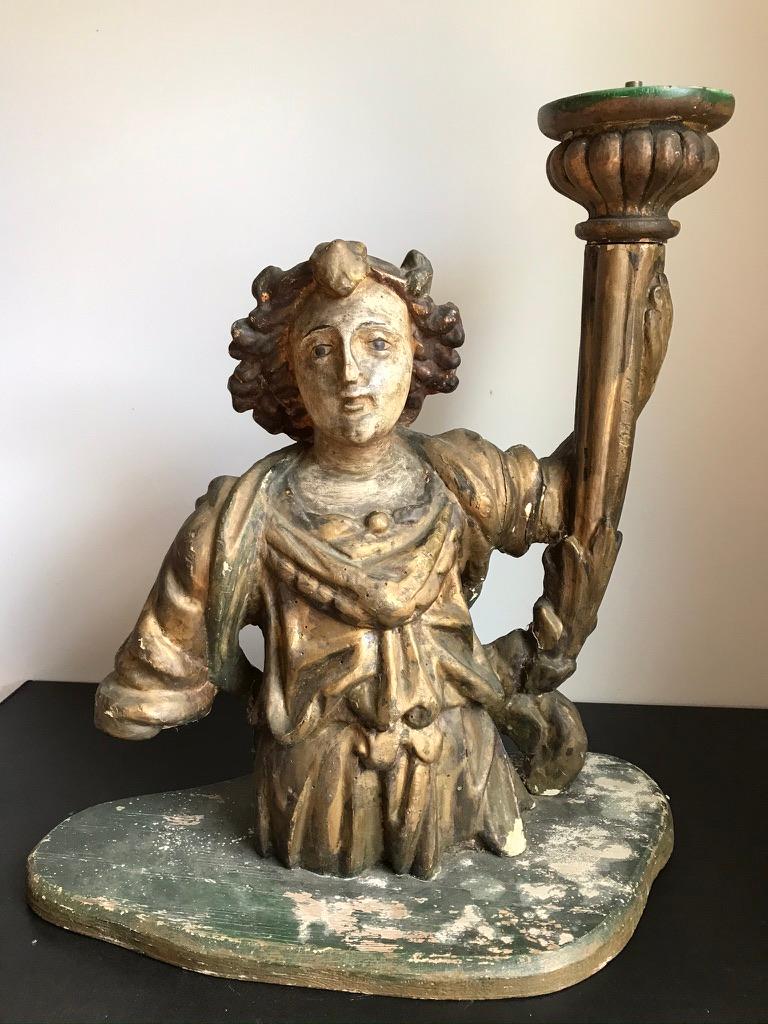 Italian carved and polychrome figure of an angel holding a torchère wearing a gilded robe. Beautifully realized face and hair, this lovely early carving had been mounted as a lamp. Great piece of Baroque sculpture that could be rewired as a lamp,