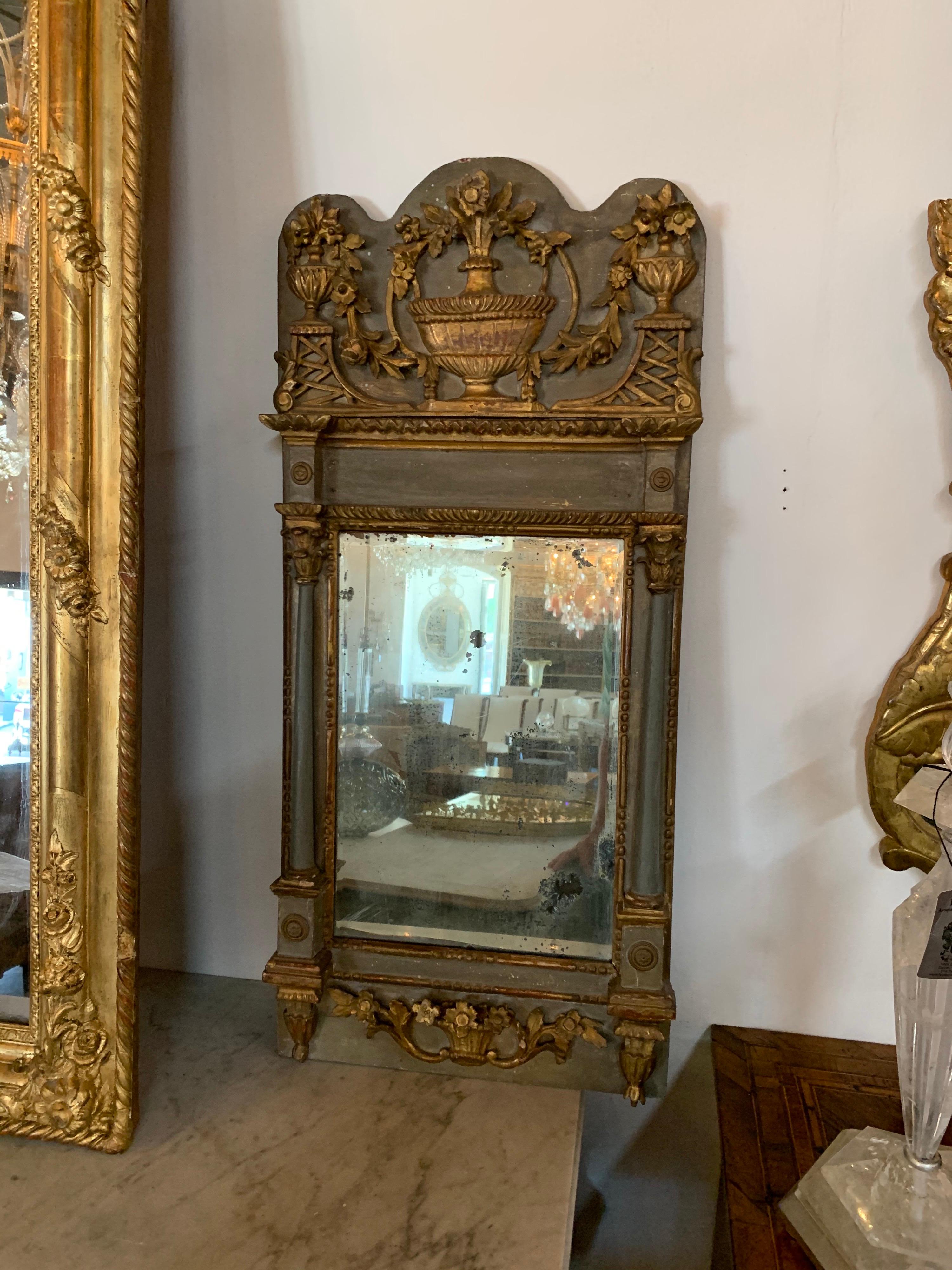 Very fine 18th century Italian carved and parcel gilt mirror with original mercury glass. Exceptional carvings including floral images and urns. Great patina as well!