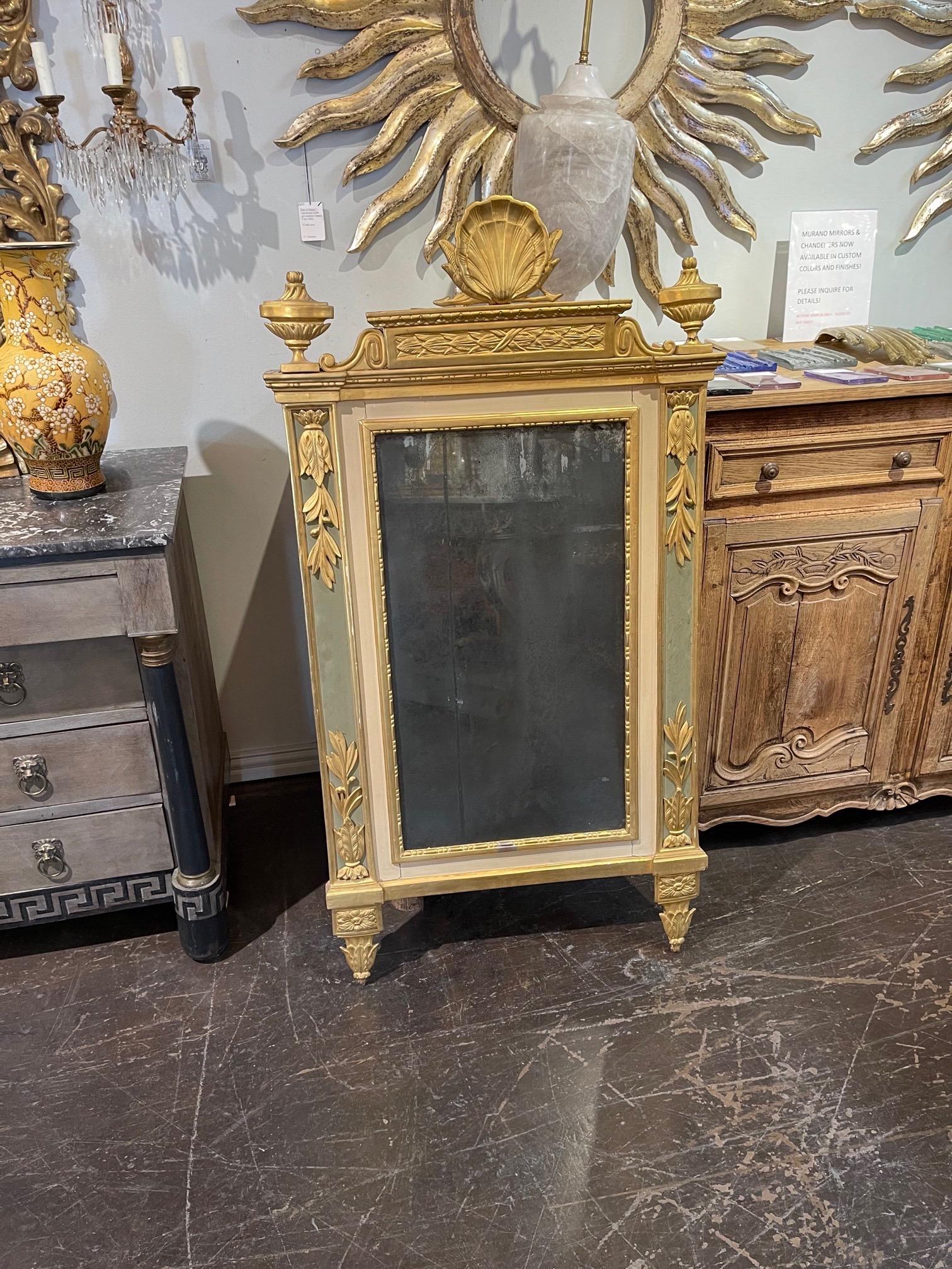 Superb 18th century Italian carved and parcel gilt mirror with original glass. Beautiful carvings including finials, floral images and a crown at the top. Painted in a pretty green and crème. Stunning!!