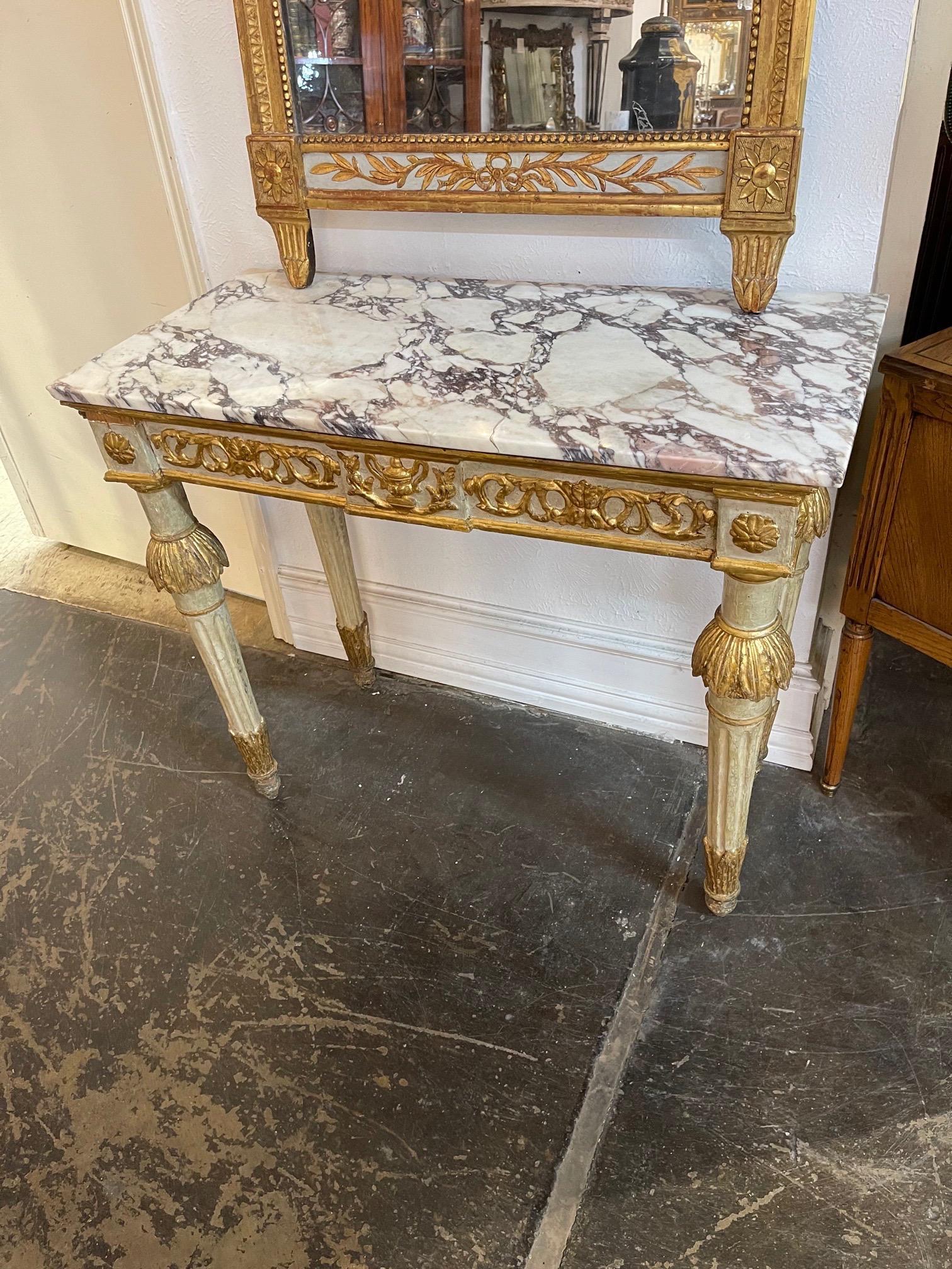 Elegant 18th century Italian carved and parcel gilt neoclassical console. Beautiful intricate carvings and a pretty marble top. An exceptional piece!! Note: There is an old repair to the original marble top.