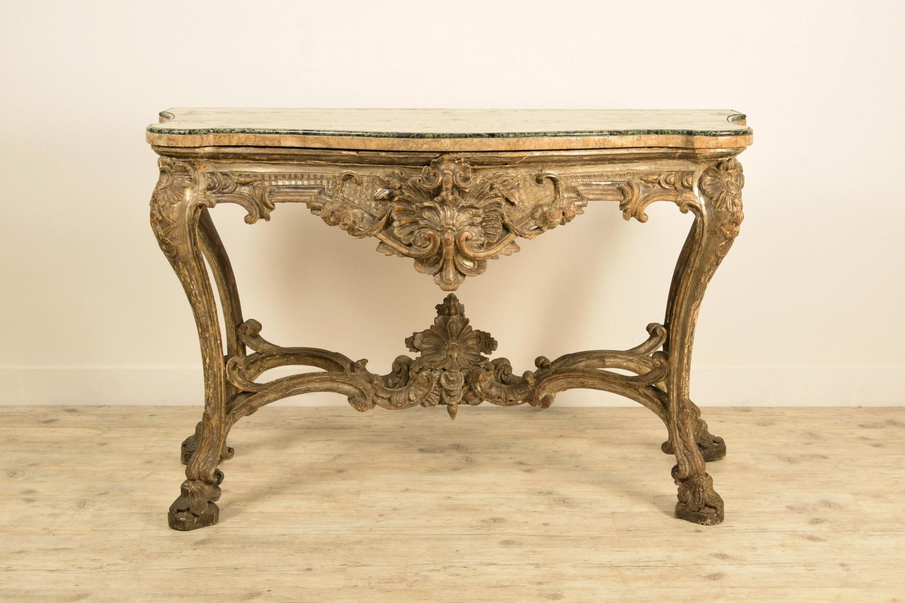 Italian carved and silvered wood console
Naples, Italy, early 18th century

This finely carved and silvered wooden console table is a remarkable example of the decorative repertoire typical of Louis XIV, with elements of particular sumptuousness