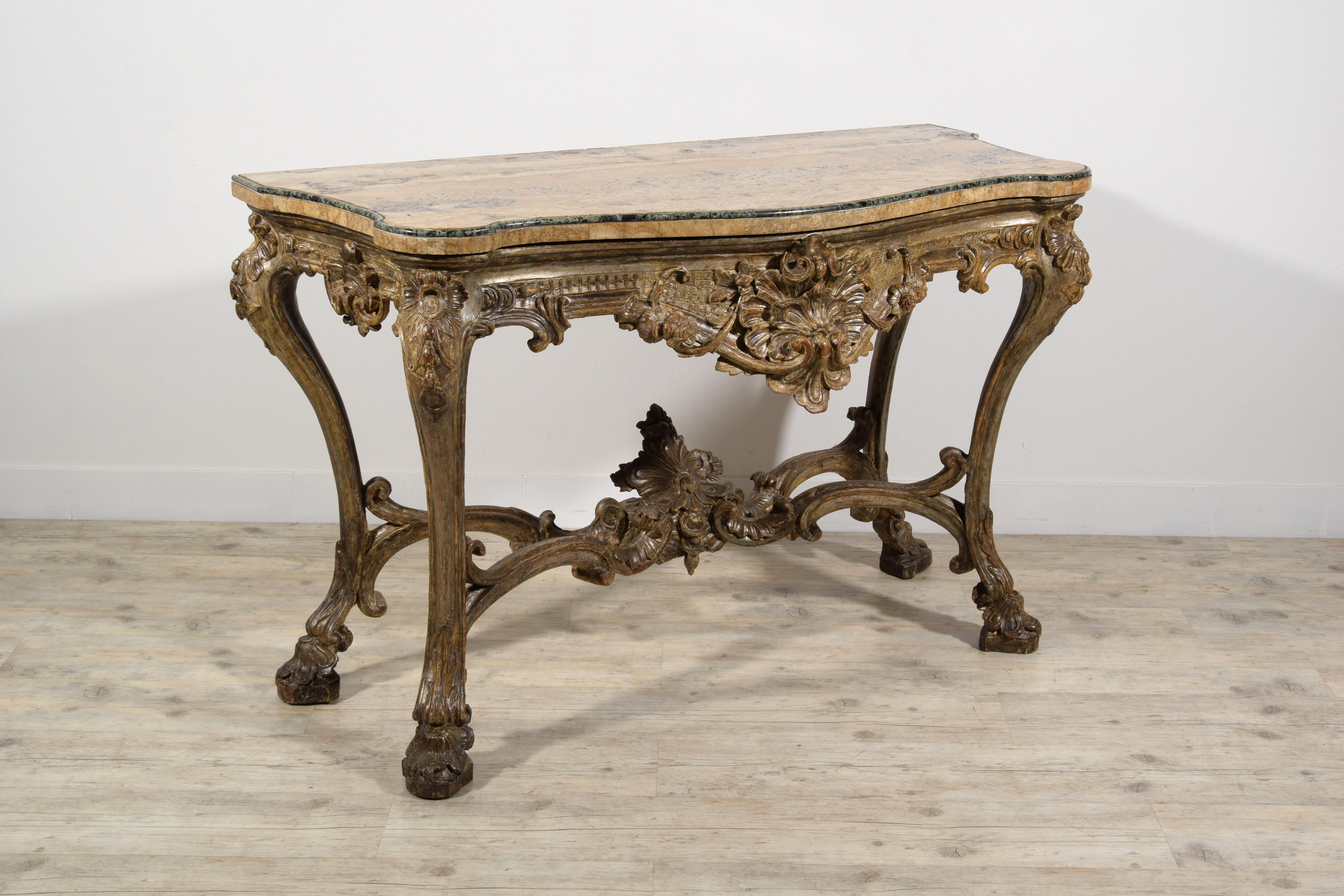 Italian carved and silvered wood consolle
Naples, Italy, early 18th century

This finely carved and silvered wooden console table is a remarkable example of the decorative repertoire typical of Louis XIV, with elements of particular sumptuousness