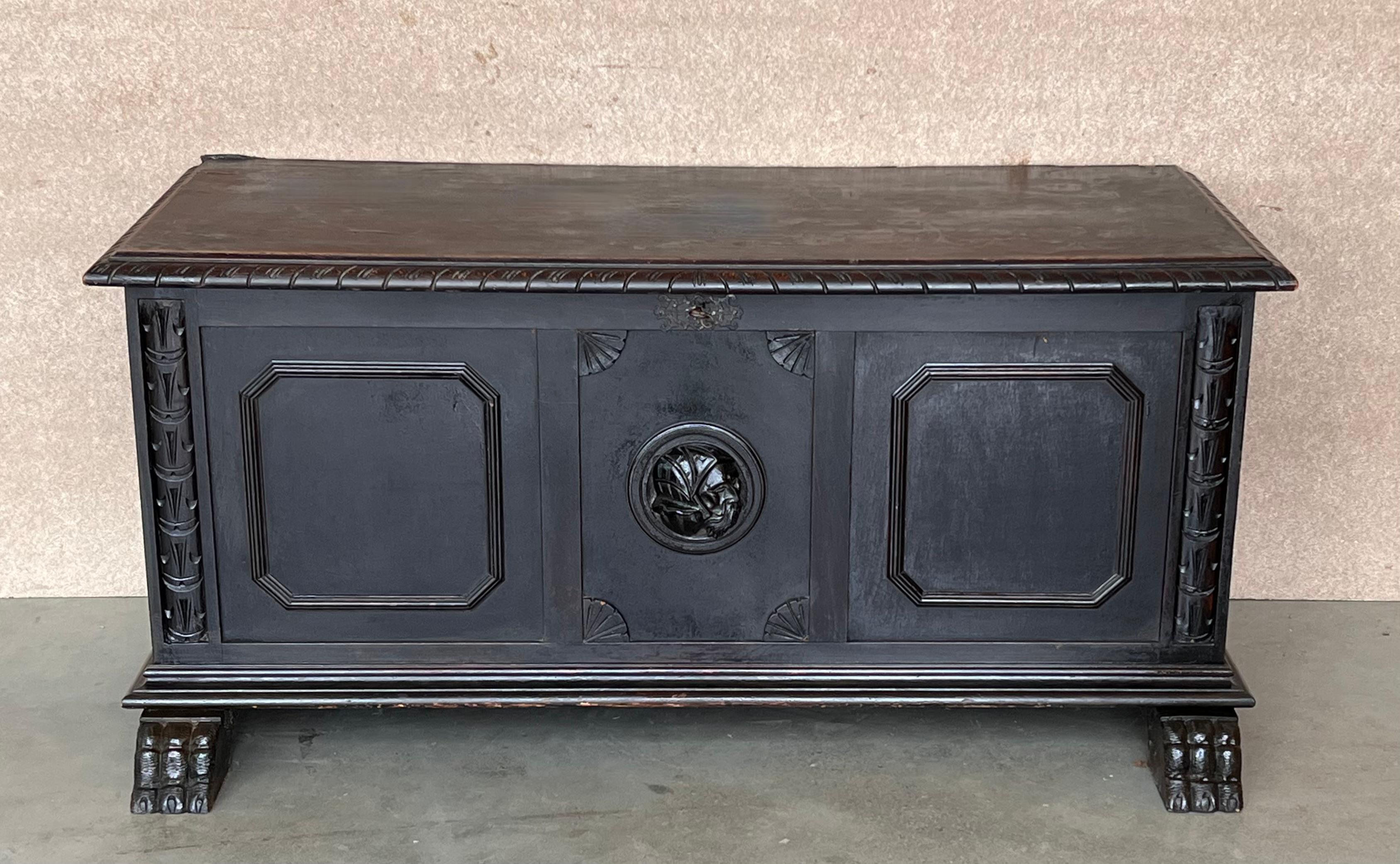 Antique carved walnut cassone coffer on paw feet from Spain, circa 1880. 
Very versatile as well: Could be used as a seating bench, or an entry piece or at the foot of a bed. Both side panels are carved as well.
The trunk its restored in a elegant