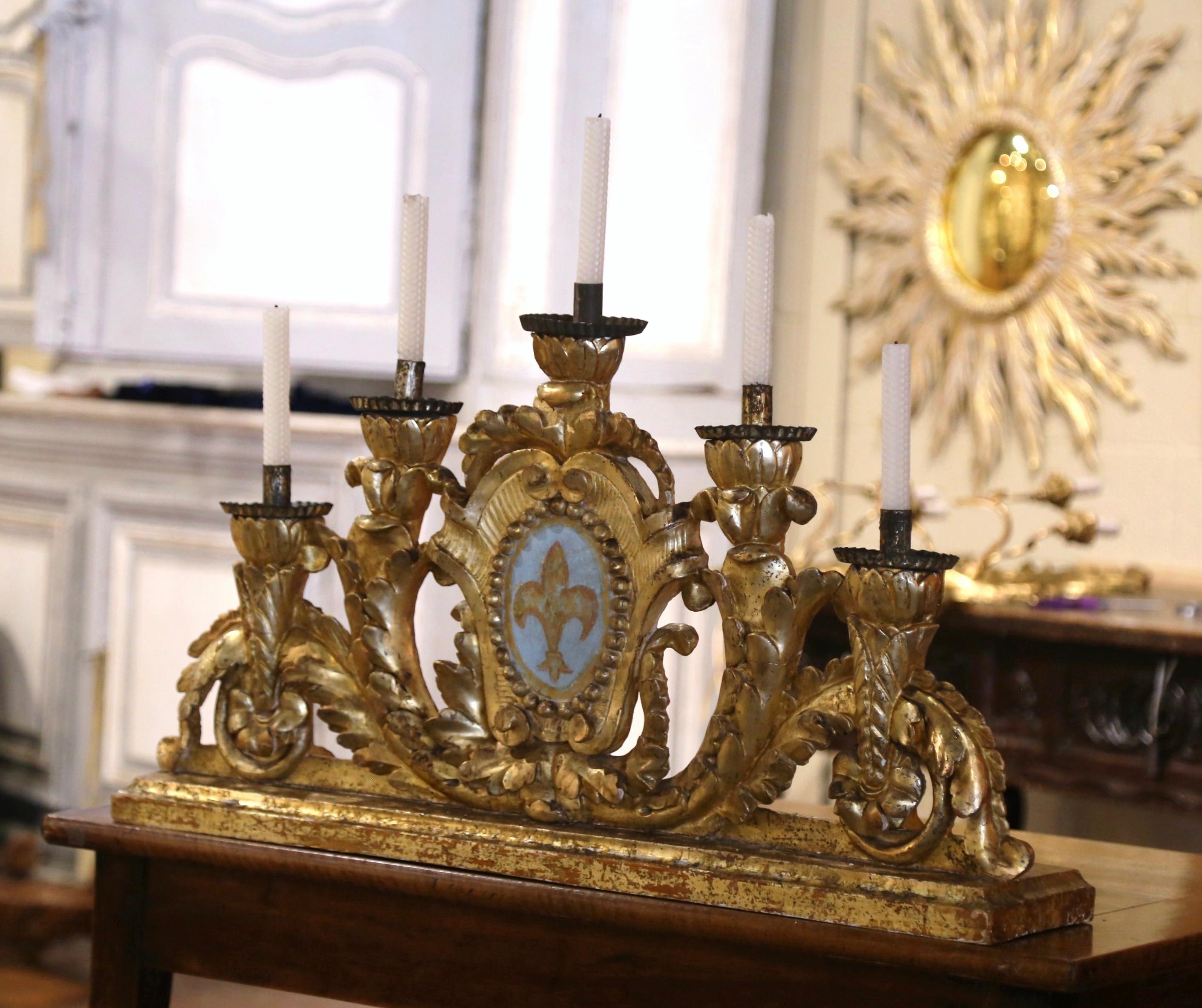 Make a statement in your home with this long, elegant, antique candelabra. Crafted in Italy circa 1780, the five-arm candelabra features an elaborate design with intricate carvings in a gilded finish, giving it a rich, opulent appearance. The focal