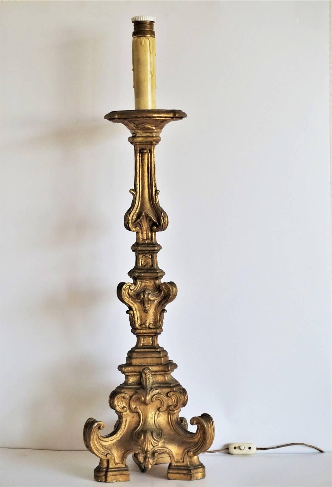 A magnificent mid-18th century Italian hand-carved giltwood altar candleholder with a large tripod base converted to a table lamp, large size bulb holder adequate to fit a lamp shade. 

Total height: 30.50 in (77 cm)
Height without candle light