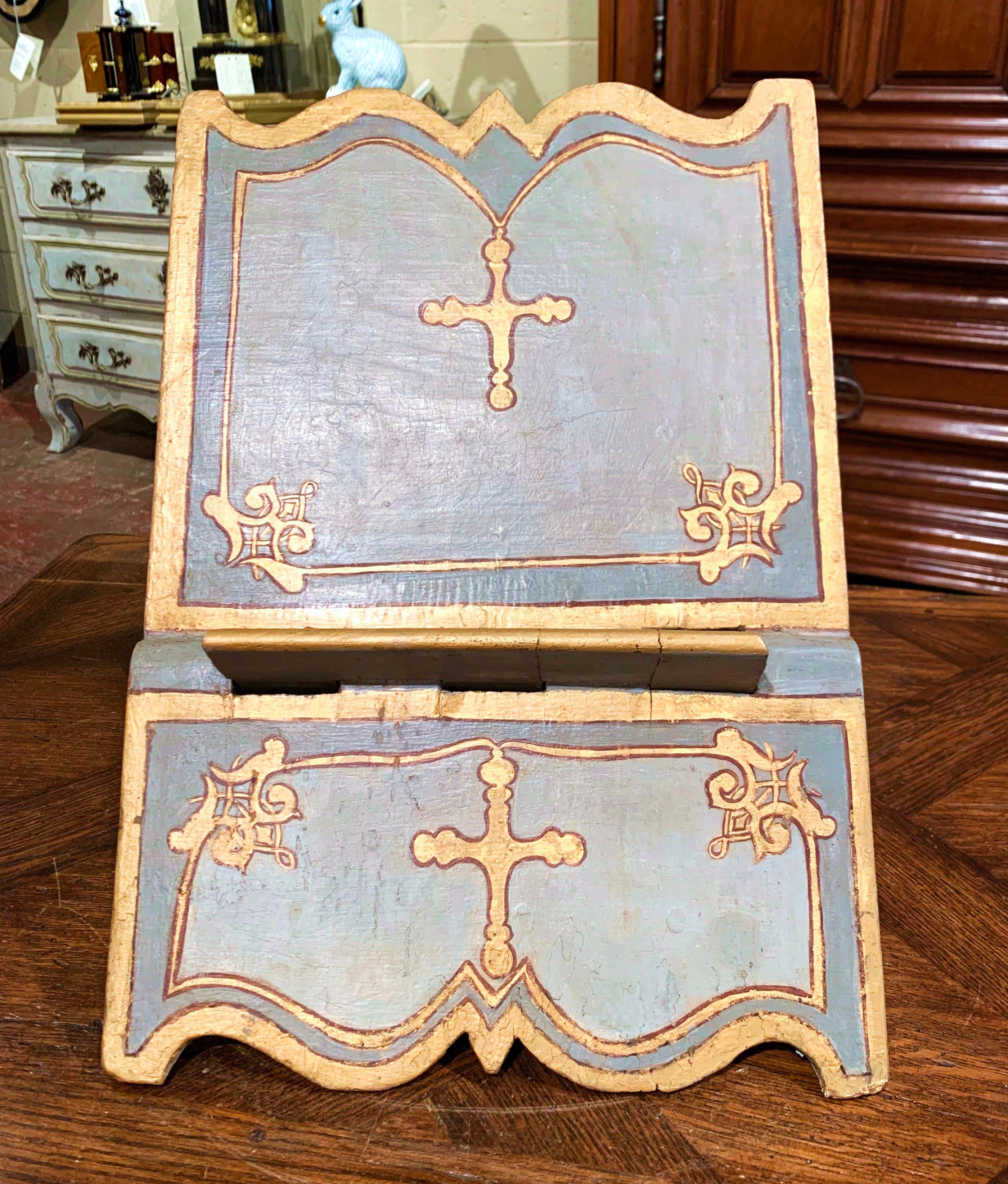 Place your Bible on this antique, baroque book stand. Crafted in Italy circa 1760, the lectern sits on two folding legs decorated with scalloped edge, and features hand painted gilt motifs including a cross on the front and one one the slant panel.