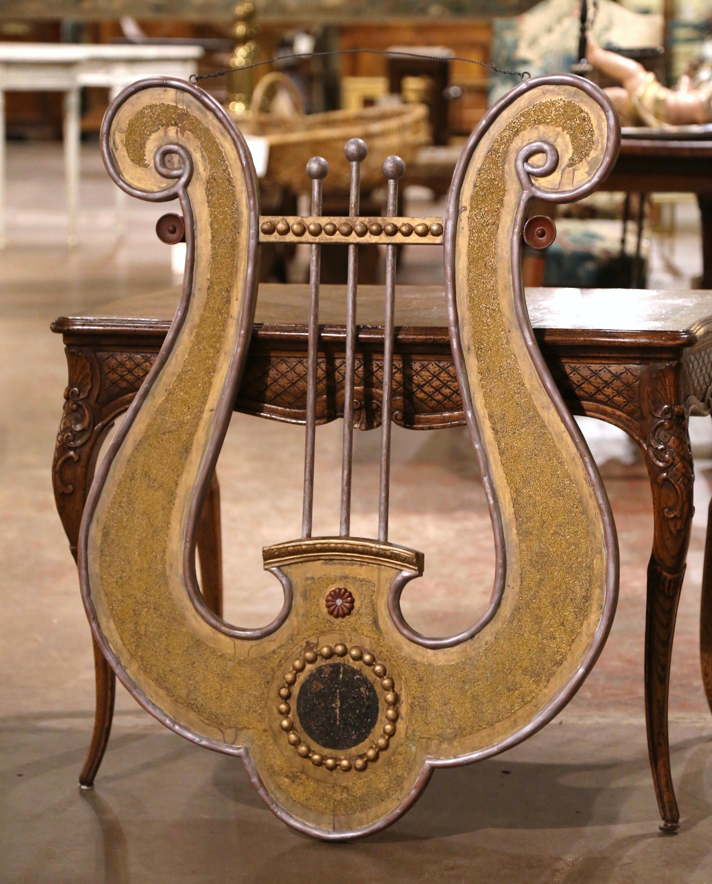 Decorate a music room, den or office with this elegant and colorful antique wall mounted lyre. Crafted in Italy circa 1780, the large Classical Roman musical instrument featured two hand carved scrolls at the top, three strings form in the center