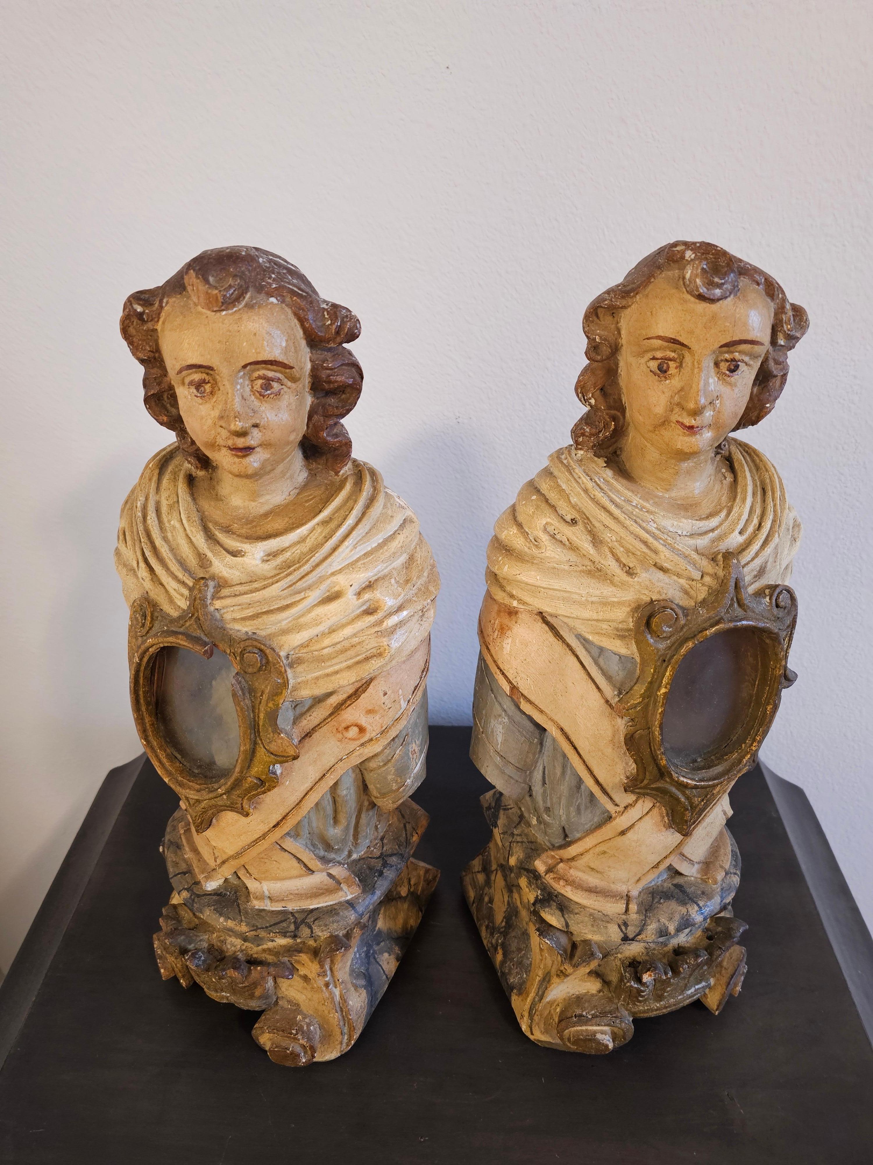 A remarkable pair of scarce large Italian Baroque period carved and painted wood church altar reliquary busts.

Born in Italy in the 18th century / possibly late 17th century, figural form, each hand carved from a single log, modeled as opposing