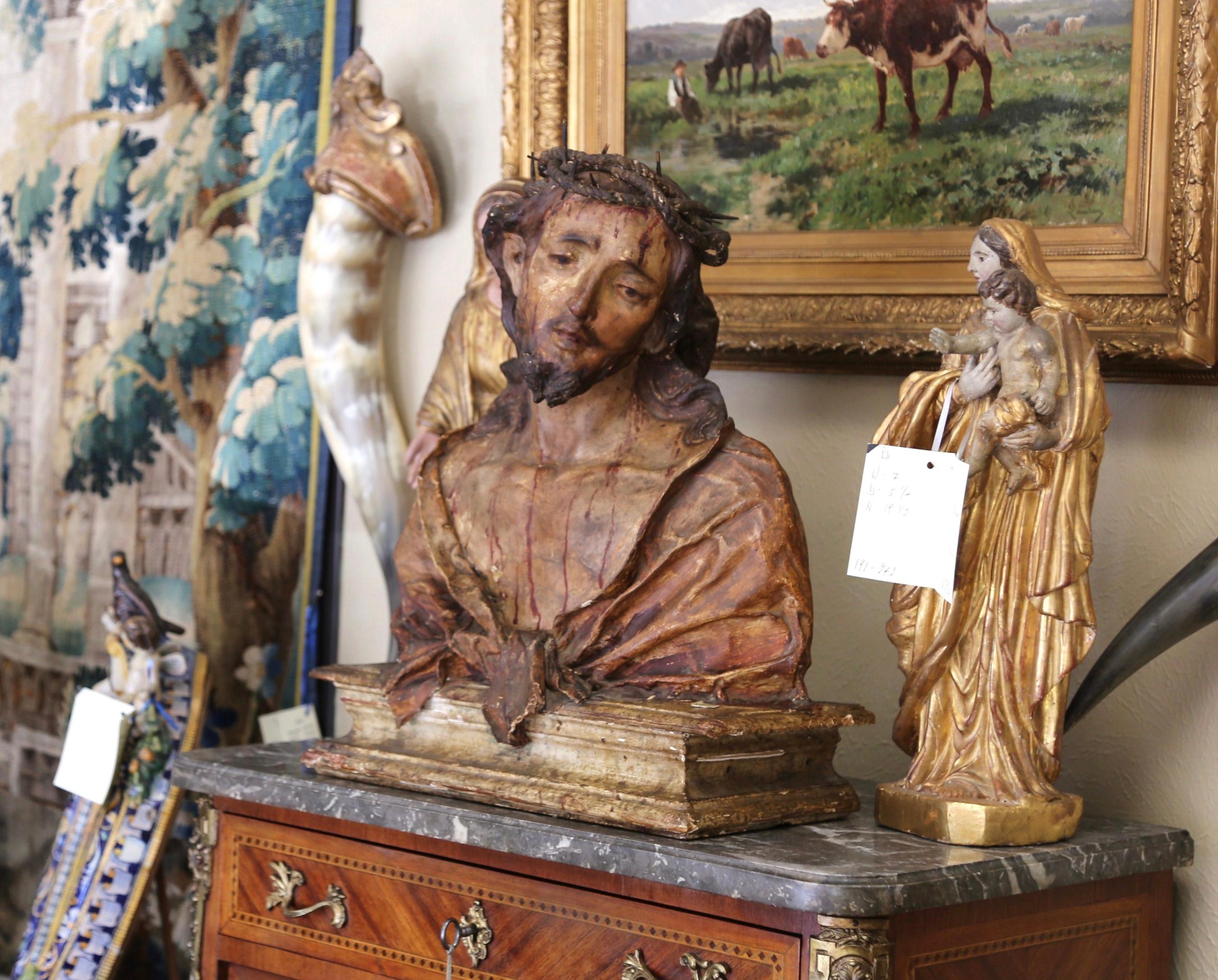 Crafted in Naples, Italy circa 1760, the carved wood and paper mâché sculpture depicts our Lord Jesus Christ on a rectangular base. The large bust shows Jesus during the crucifixion dressed with his robe, the crown of thorns on his heads and drops