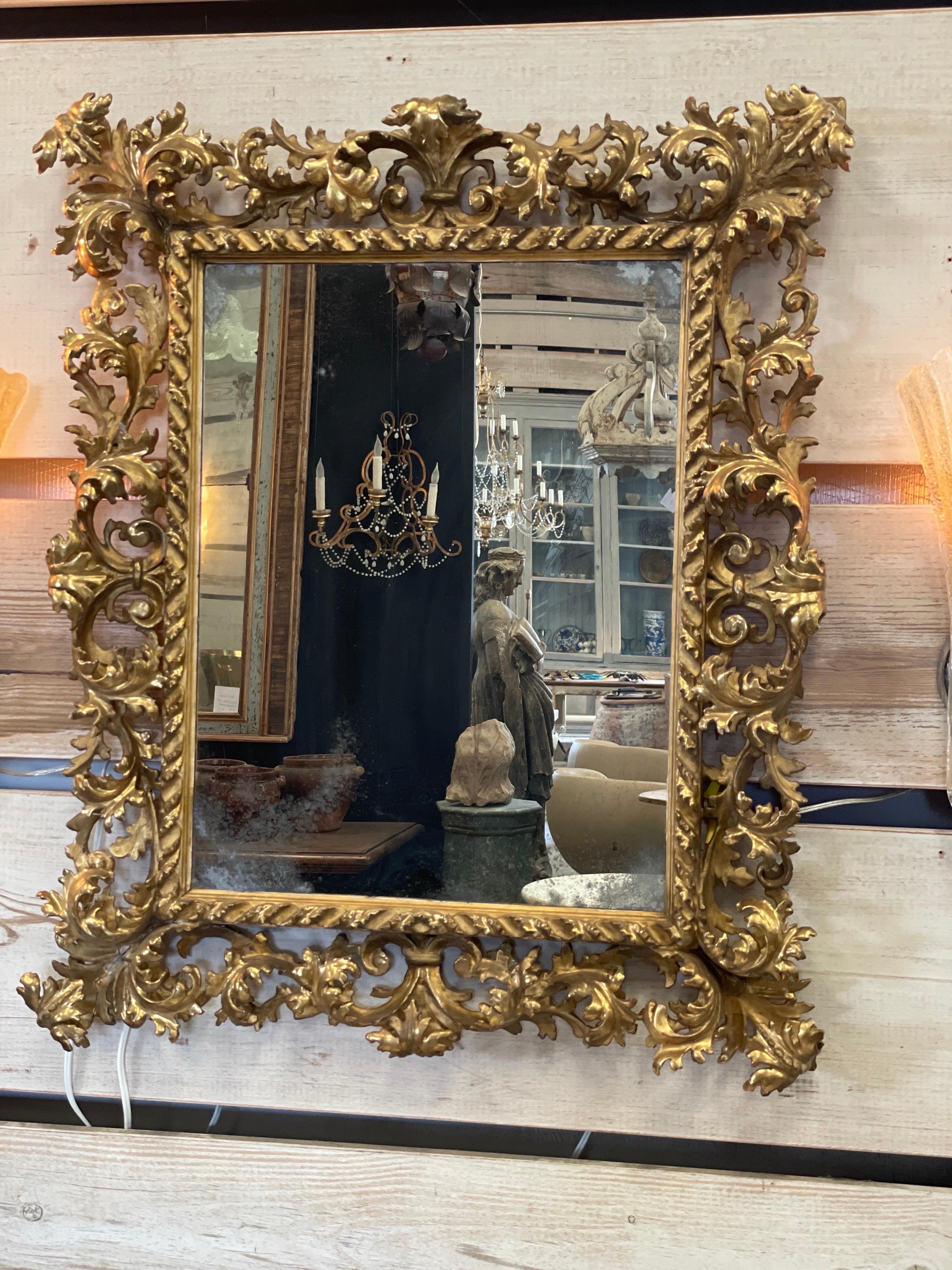 Elegant hand carved masterpiece of a mirror from the 18th century Italy.  It’s a great size about a medium chest or powder bathroom.
The glass has been changed at a later date.
31” w x 37” t x 4”d