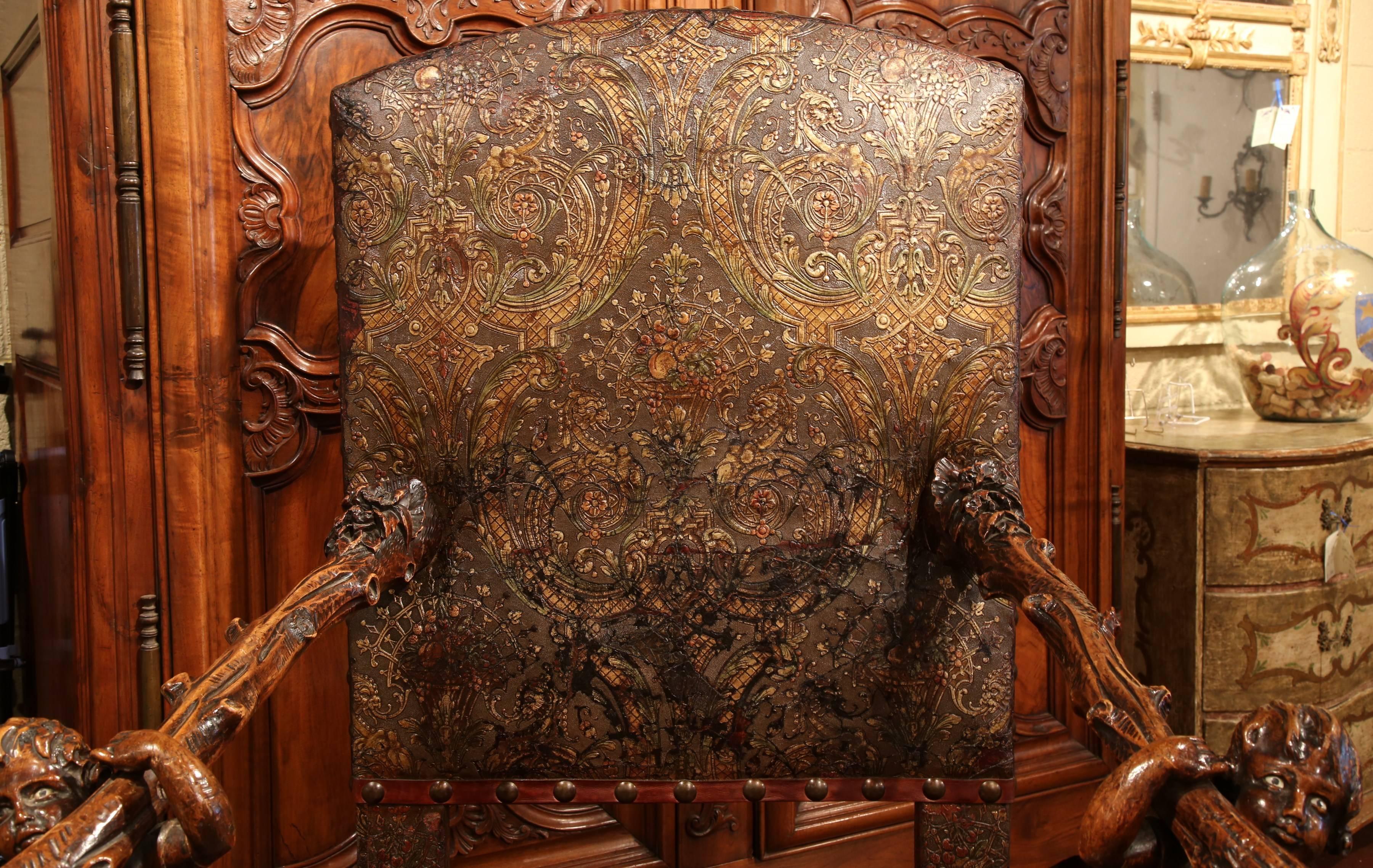 Place this large antique fruitwood armchair in your study or library; crafted in Italy, circa 1760, the elegant chair with an arched back features exquisite carvings including a pair of youngsters holding the armrests, four curved legs shaped as
