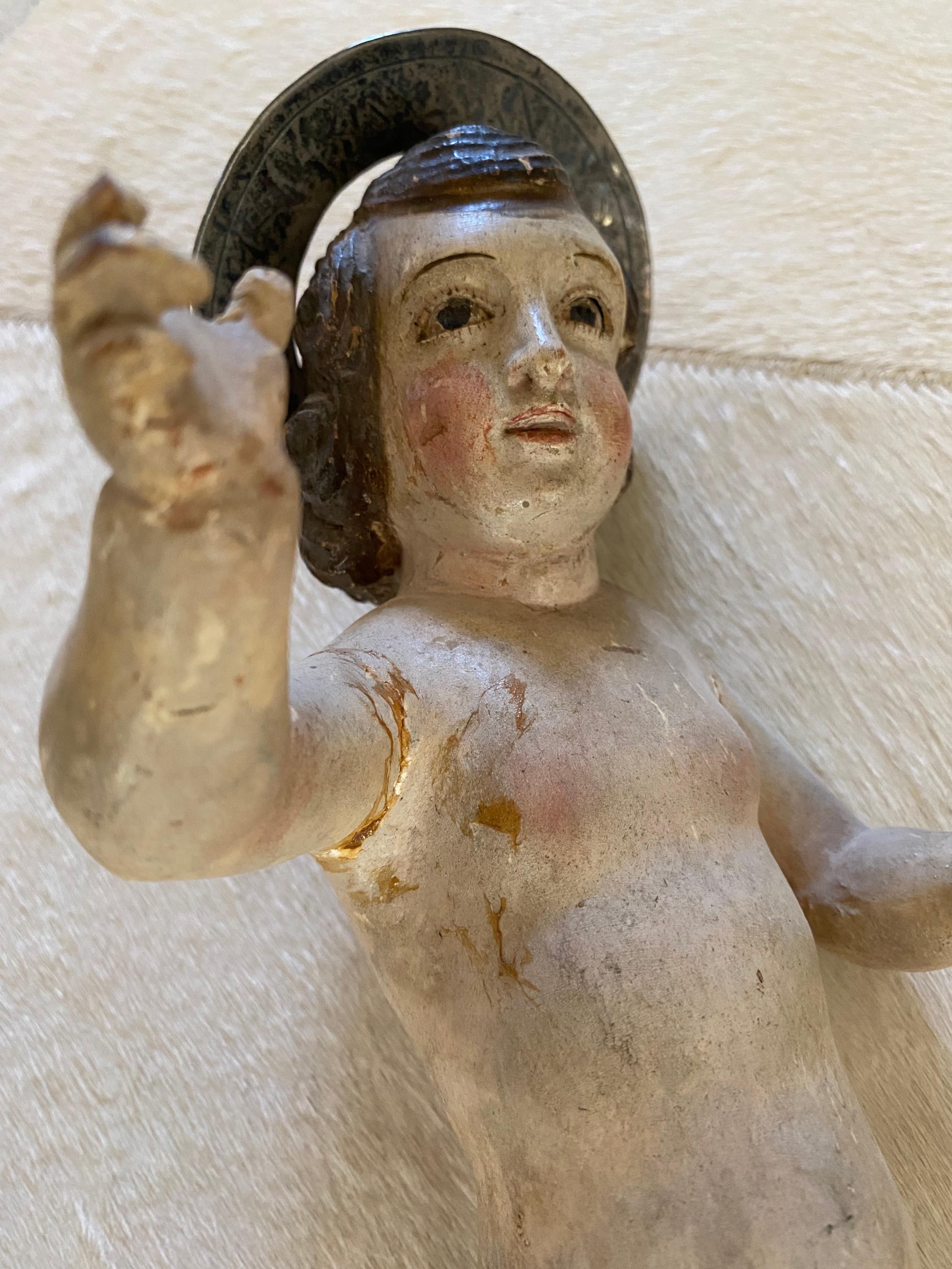 18th century exceptional Italian carved wood and polychromed figure depicting baby Jesus holding the world in his hand, he has halo made from sterling silver and the globe is also sterling silver.This piece would have originally been dressed in an