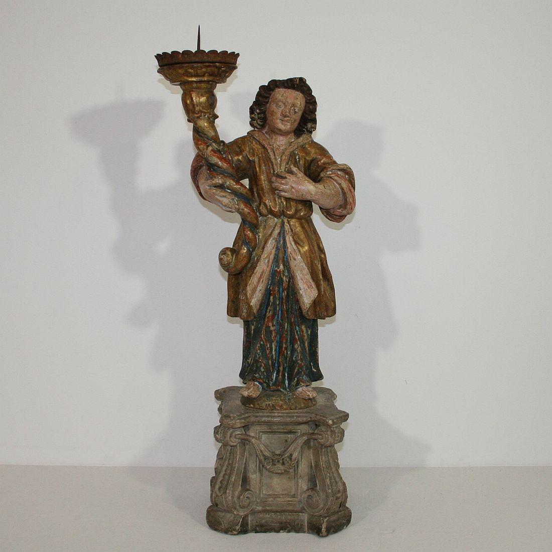 Stunning period piece. Baroque angel with its original color holding a torchère. Very beautiful piece.
Italy, circa 1750. Weathered, old repairs and small losses.
 