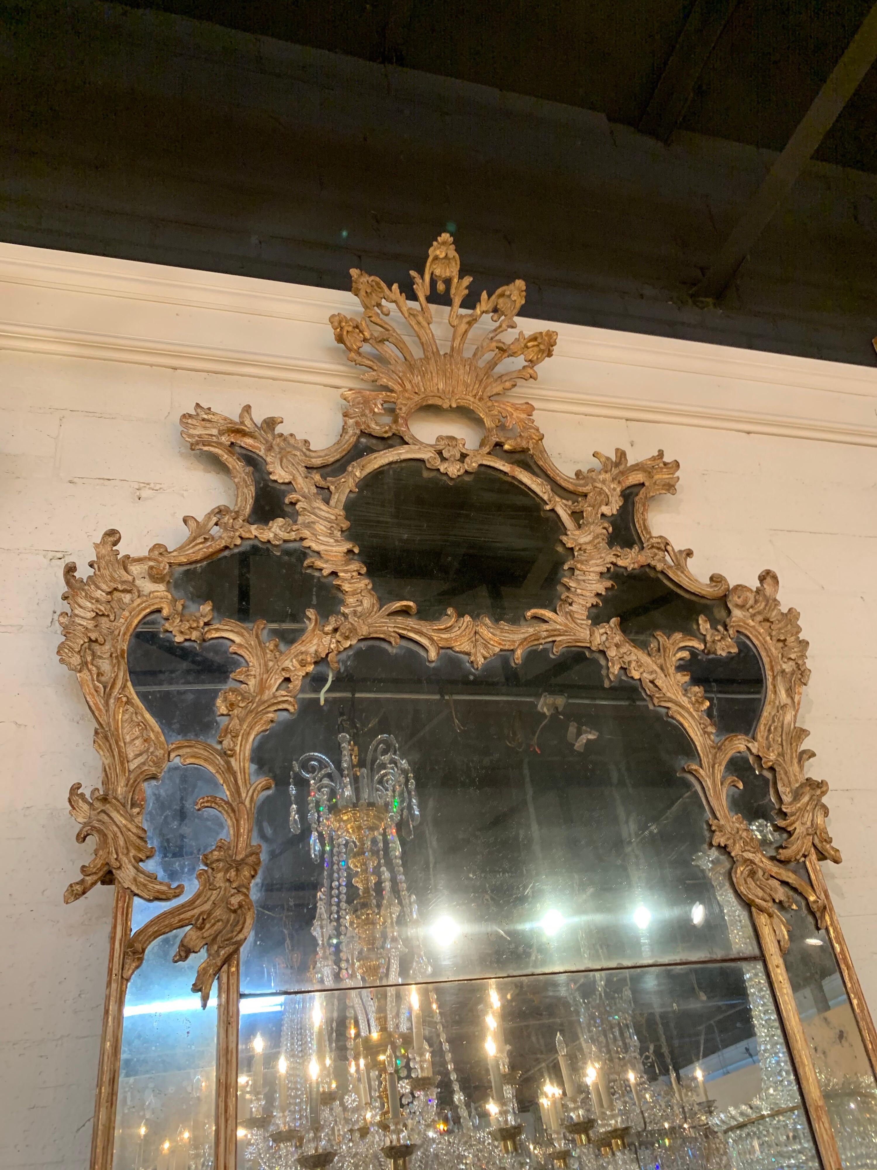 Gorgeous large scale 18th century Italian carved wood mirror with 2 panels. The panels are original mercury glass. Very fine carving on the wood and the patina is really nice as well. So pretty!