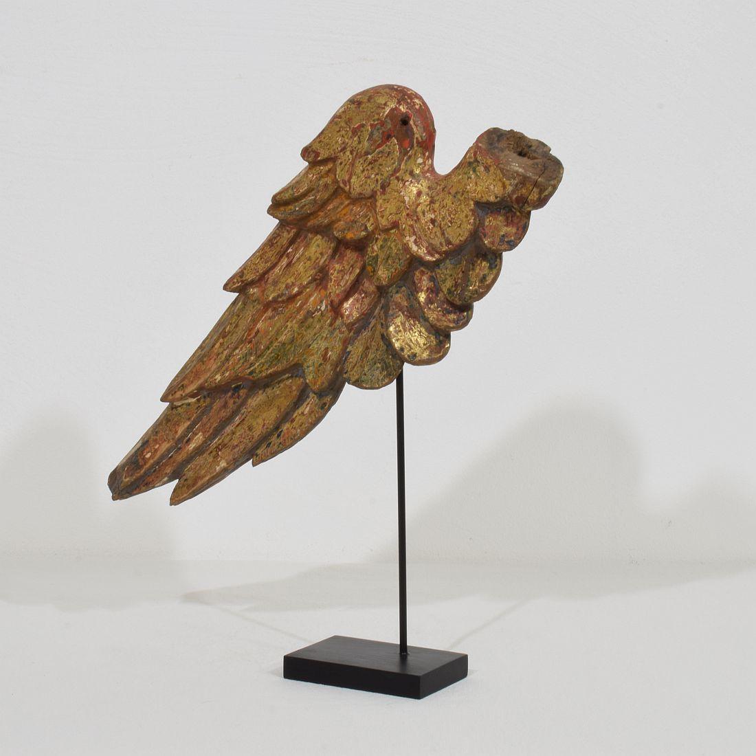 Beautiful Baroque angel-wing. Rare and very decorative item placed on a wooden base, Italy, circa 1750. Weathered. Measurement is inclusive the wooden base.